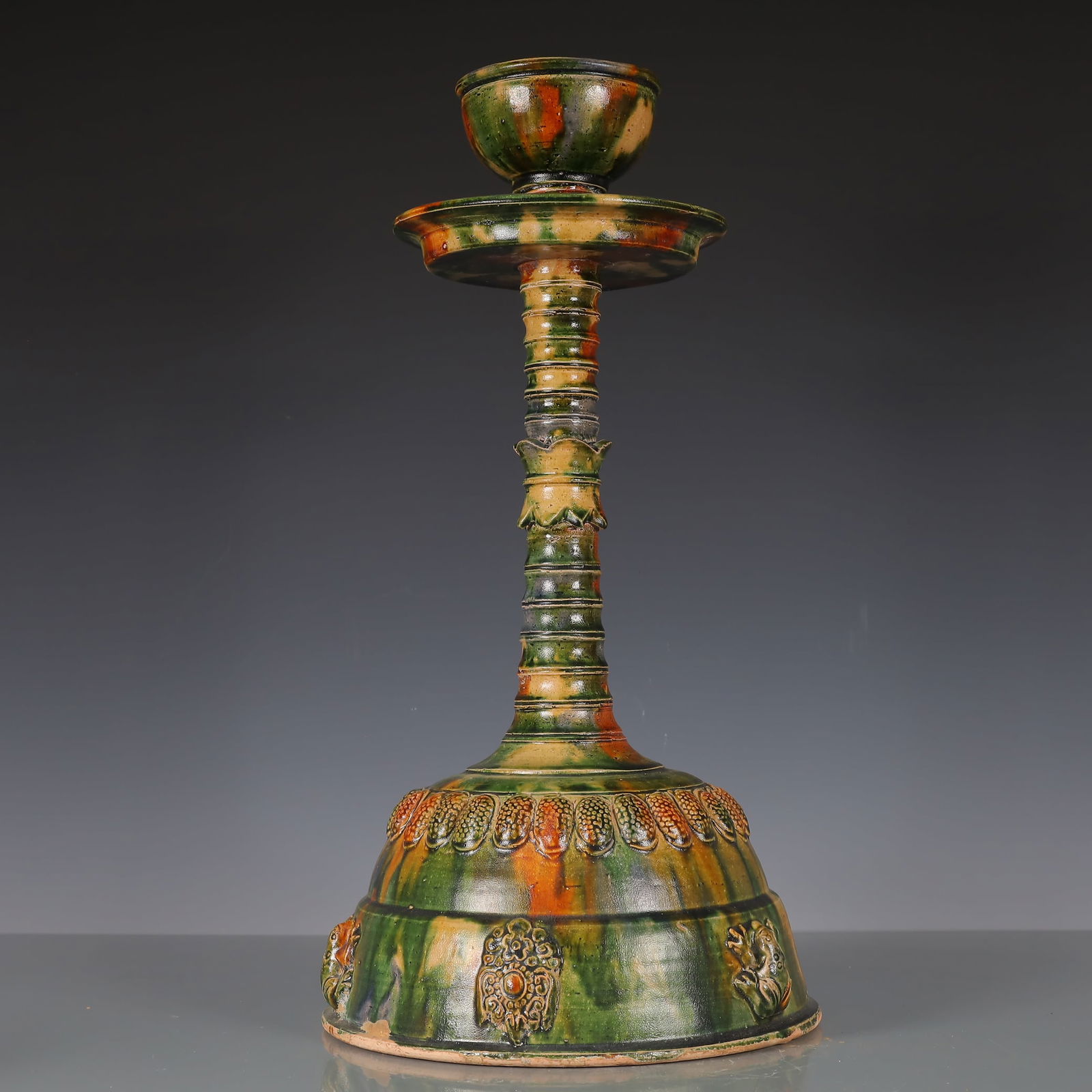 A Exquisite Trio-colored glazed pottery of the Tang Dynasty Flower Pattern Candlestick: A Exquisite Trio-colored glazed pottery of the Tang Dynasty Flower Pattern Candlestick Tang Dynasty, China Size:25cmx25cmx48cm Weight:3050g (The Dimensions Of All Batches Are Manually Measured.If You