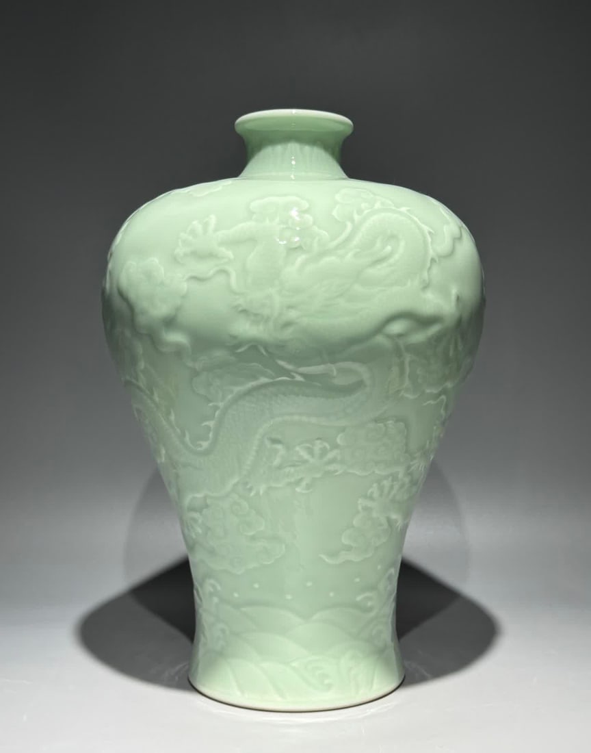 A Qing Qianlong model bean celadon carved dragon cloud sea pattern plum bottle: Qing Qianlong model bean celadon carved dragon cloud sea pattern plum bottle SIZE: H:35cm W:23cm