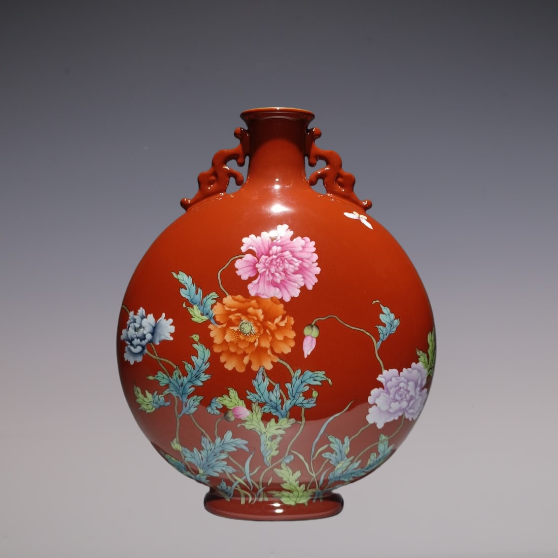 An Exquisite Enamel Coral Red Glazed Flower and Butterfly Pattern Double-Ears Vase: An Exquisite Enamel Coral Red Glazed Flower and Butterfly Pattern Double-Ears Vase Qing Dynasty, China Qianlong Four-character Mark Size:31.8cmx25.3cm (The Dimensions Of All Batches Are Manually Measu