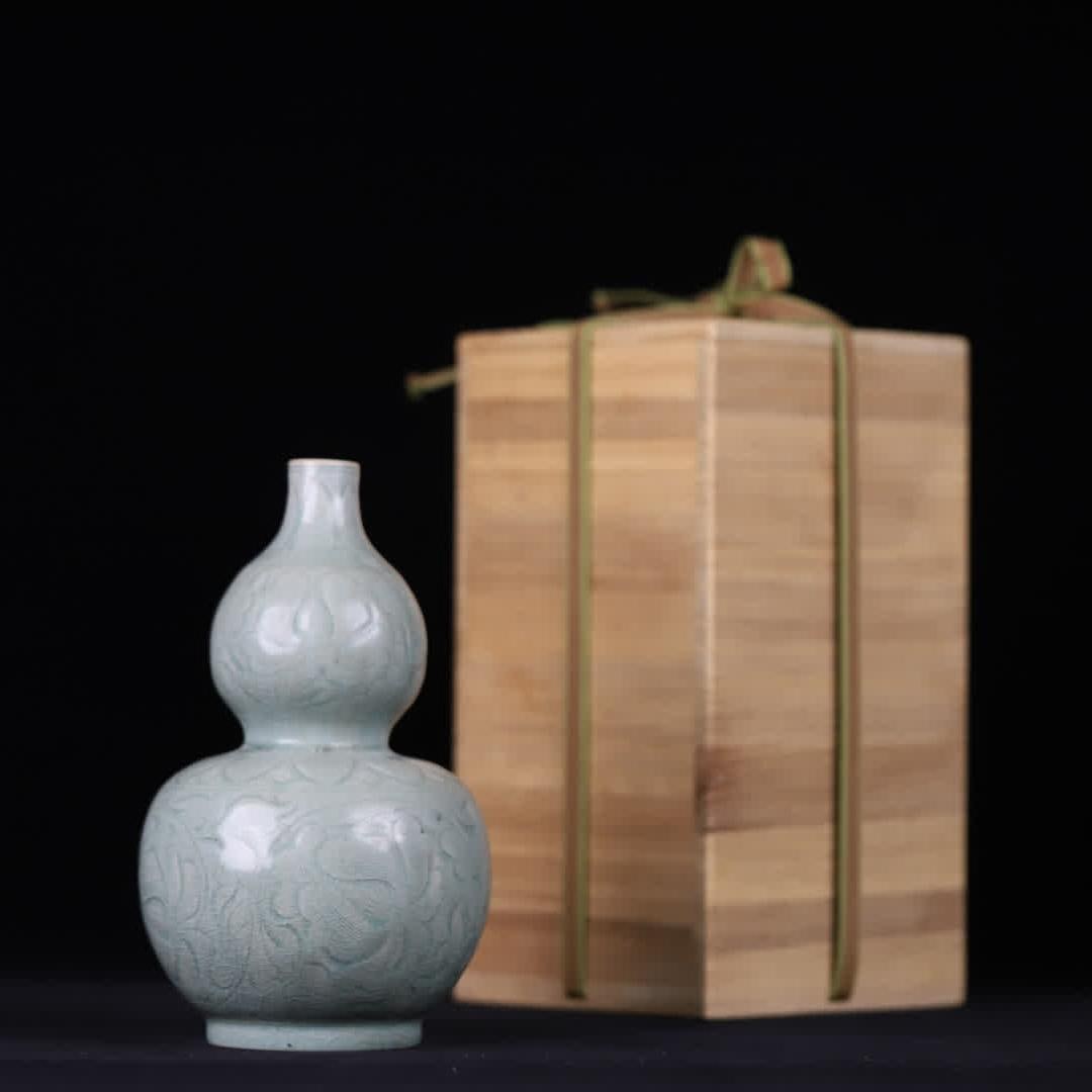 A Song Dynasty celadon carved gourd bottle (1 of 9)