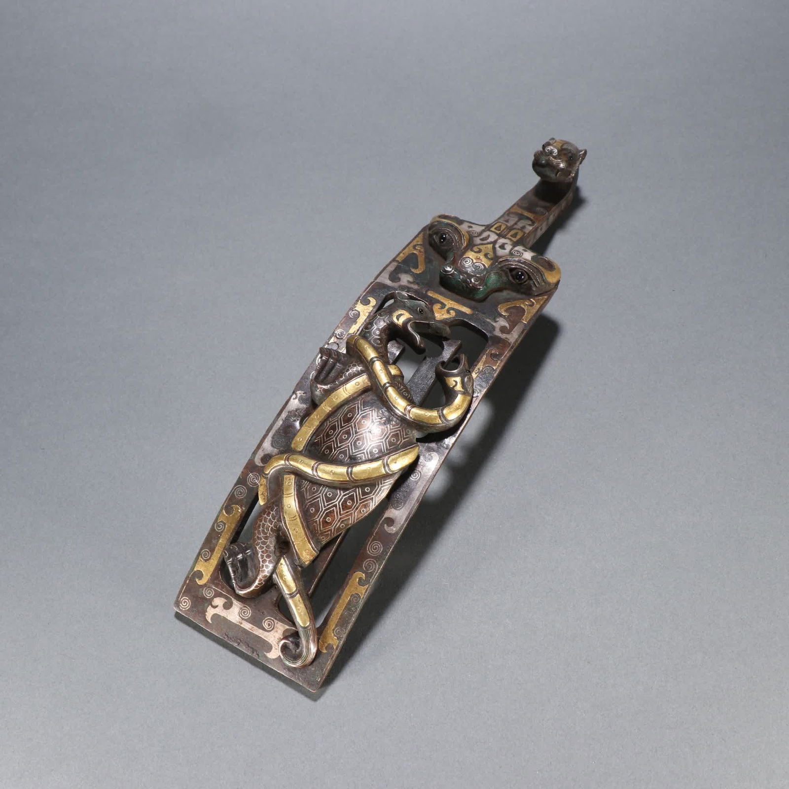 A Han Dynasty copper cuo gold and silver basalt belt hook (1 of 9)