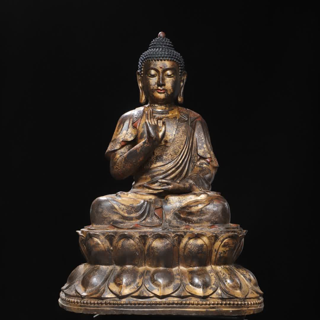 A statue of the Buddha in copper clay and gold (1 of 9)