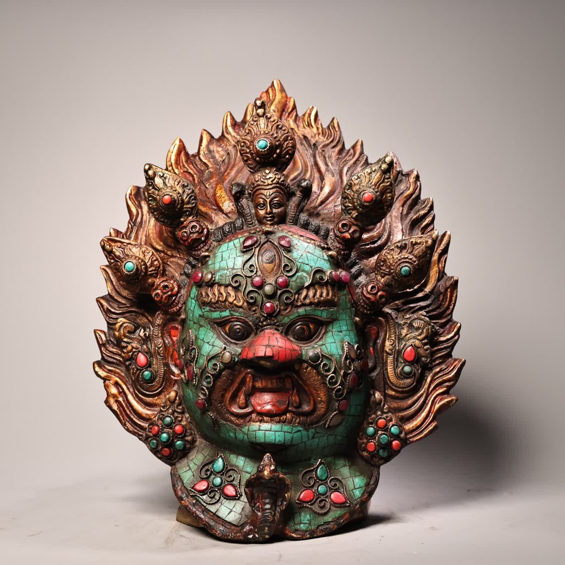 A Tibetan jewel-inlaid gold-painted Mahakala hanging head (1 of 10)