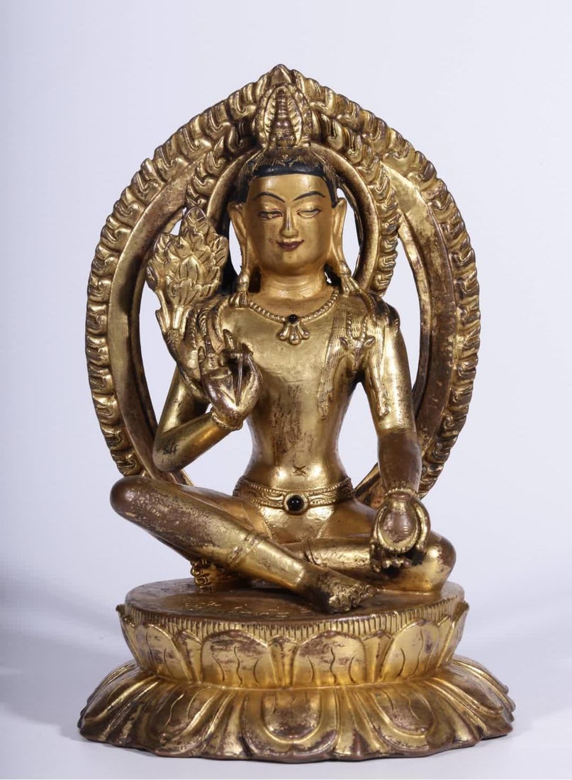 A Qing Dynasty copper gilt seated statue of Guanyin holding a lotus (1 of 9)