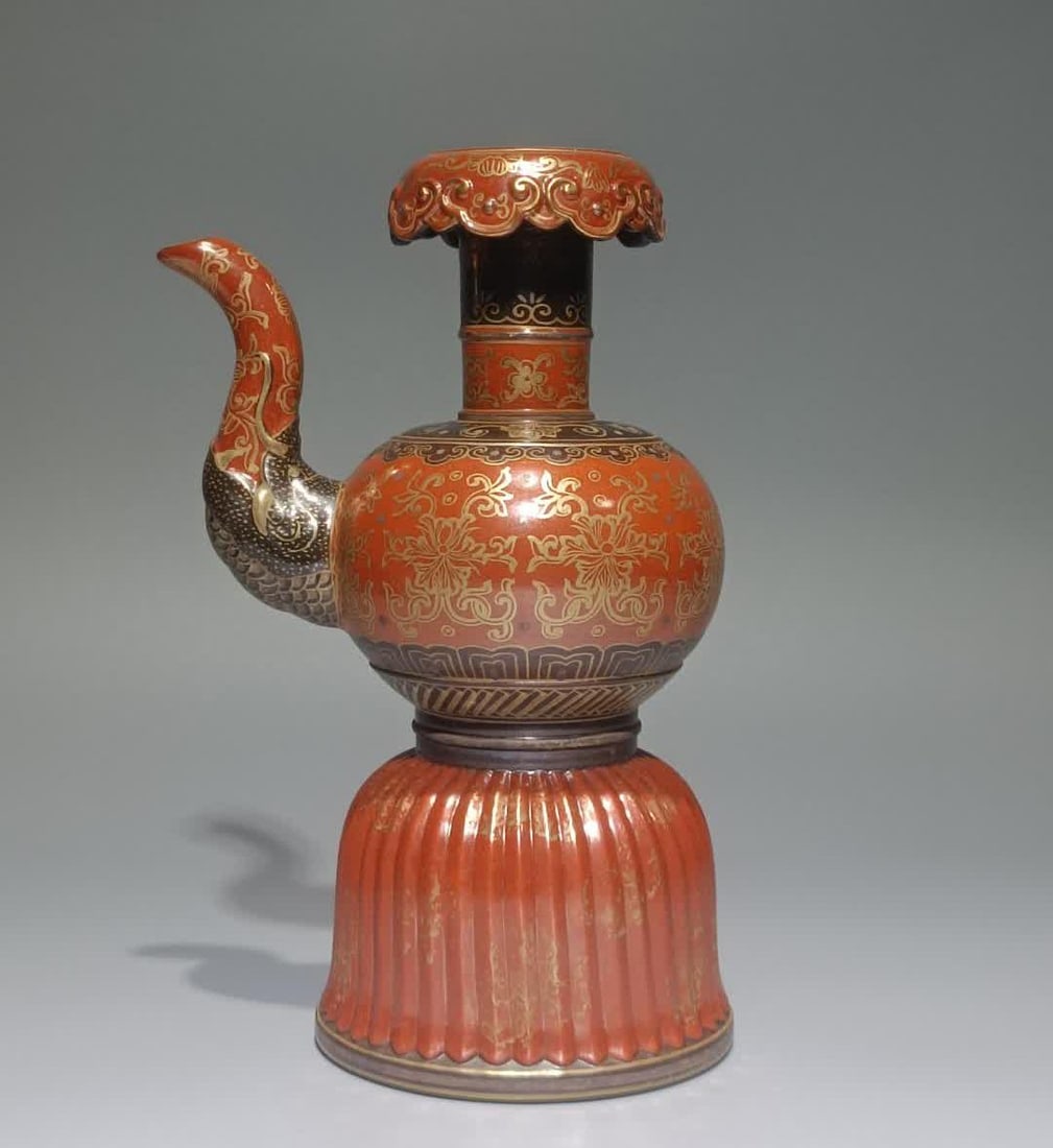 A Qing Qianlong bronze glazed alum red gold-painted Benba pot (1 of 9)