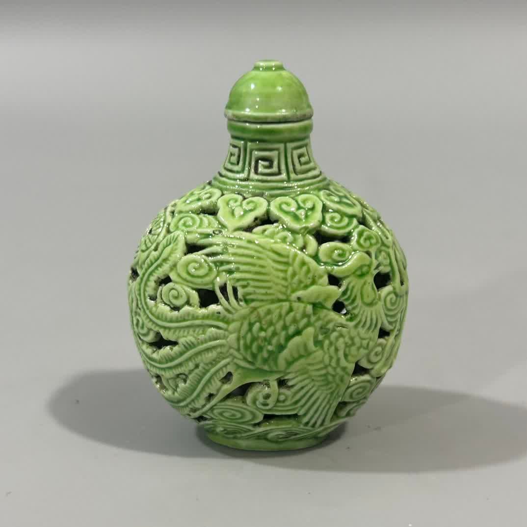 A Qing Dynasty green dragon and phoenix hollow snuff bottle (1 of 7)