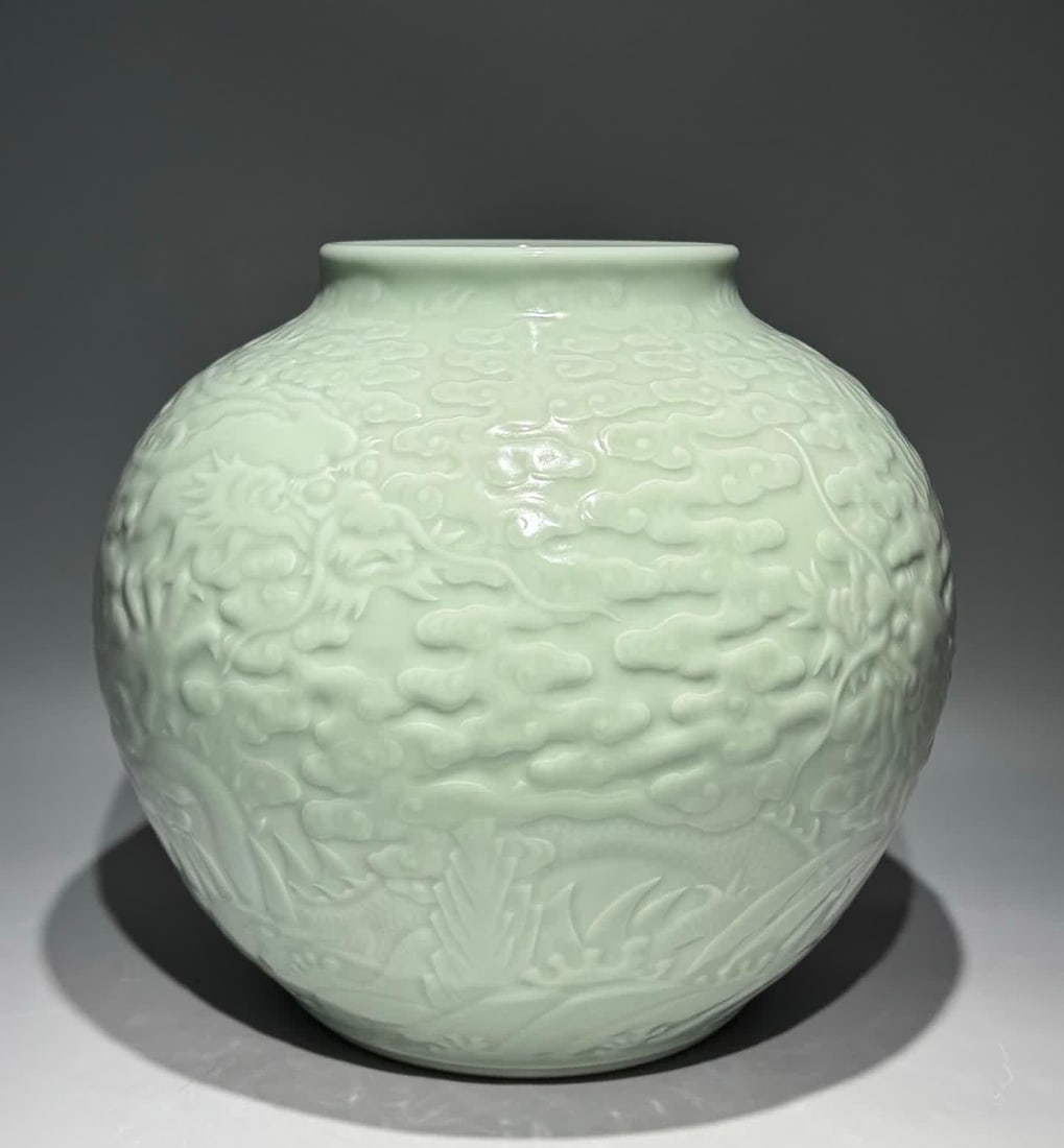A Qing Qianlong bean blue glaze carved Canglong godson Xiangyun Shoushan Fuhai pattern jar (1 of 9)