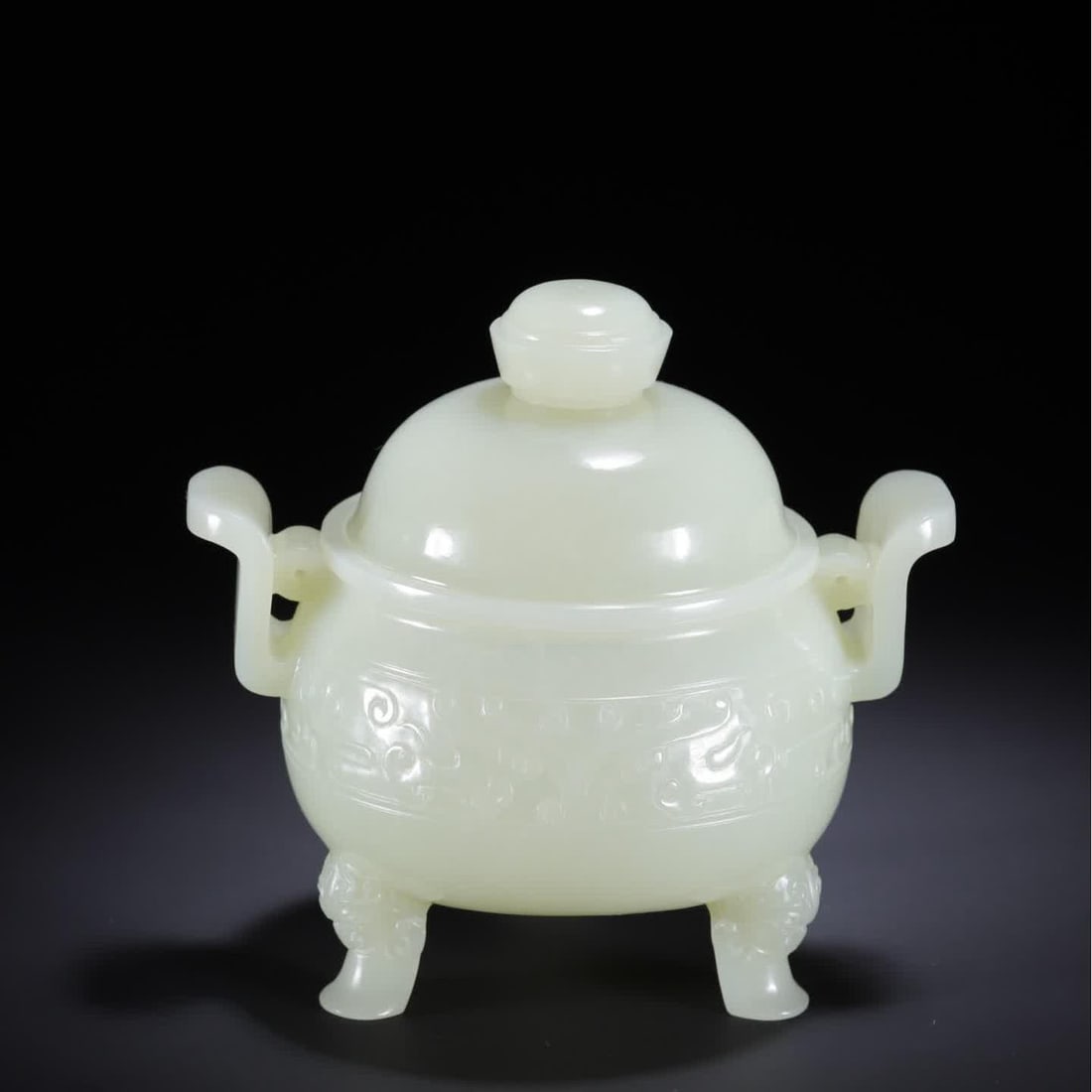 A Qing Dynasty Hetian jade gluttonous pattern curved ear three-legged: Qing Dynasty Hetian jade gluttonous pattern curved ears three-legged SIZE: 12.2x9.2x9.0cm W:340g (The Dimensions Of All Batches Are Manually Measured.If You Need More Detailed Information, Please Cont