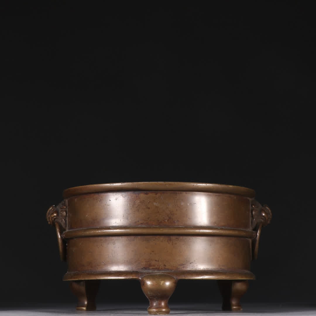 A Ming Dynasty Xuande bronze three-legged incense burner (1 of 9)