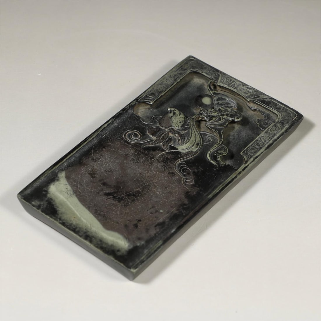 A Qing Dynasty longevity peach bat pattern end inkstone (1 of 6)