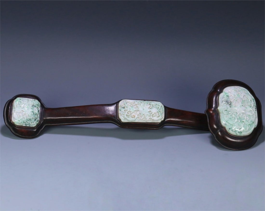 A beautiful rosewood inlaid jadeite entwined floral pattern ruyi ornament: Exquisite rosewood inlaid jade entwined floral pattern ruyi ornament Size:44.5x13.3x7.8cm W:1703g (The Dimensions Of All Batches Are Manually Measured.If You Need More Detailed Information, Please Con
