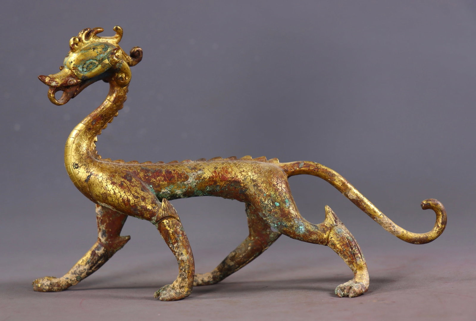 An Exquisite Gilt Bronze Dragon Ornament: An Exquisite Gilt Bronze Dragon Ornament Han Dynasty, China Size:15cmx22cmx7.5cm Weight:700g (The Dimensions Of All Batches Are Manually Measured.If You Need More Detailed Information, Please Contact