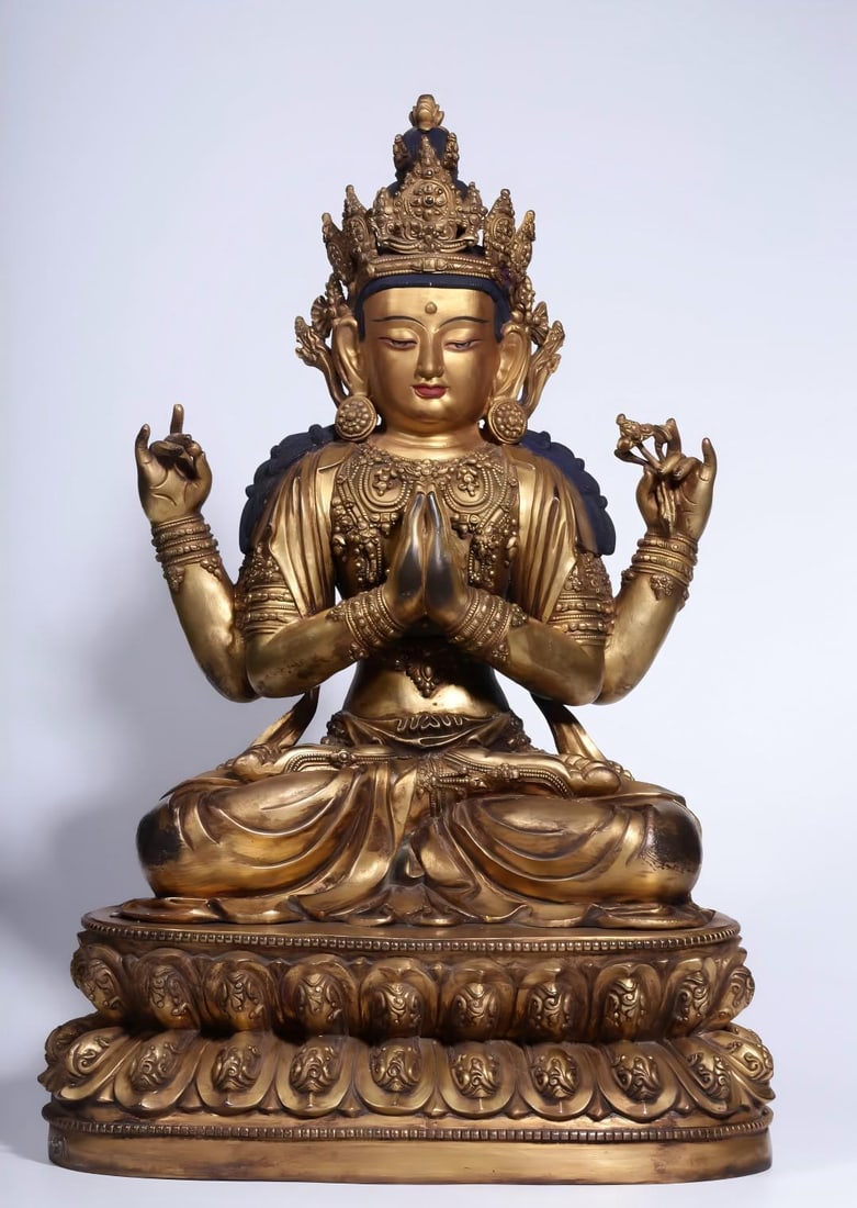 A seated statue of Guanyin with four arms in copper gilt in the Qing Dynasty (1 of 11)