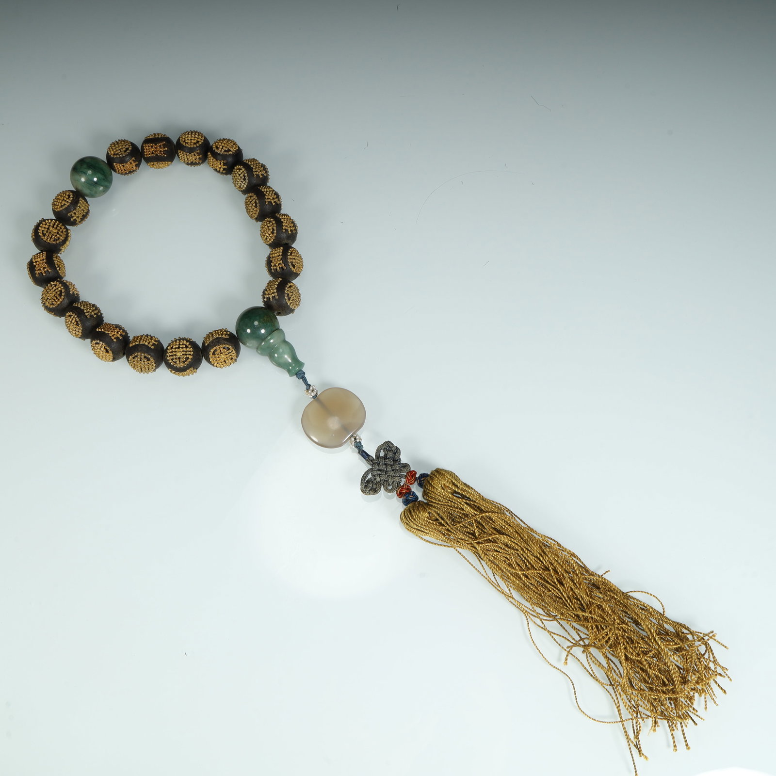 A Qing Dynasty agarwood inlaid gold group longevity pattern bracelet (1 of 9)