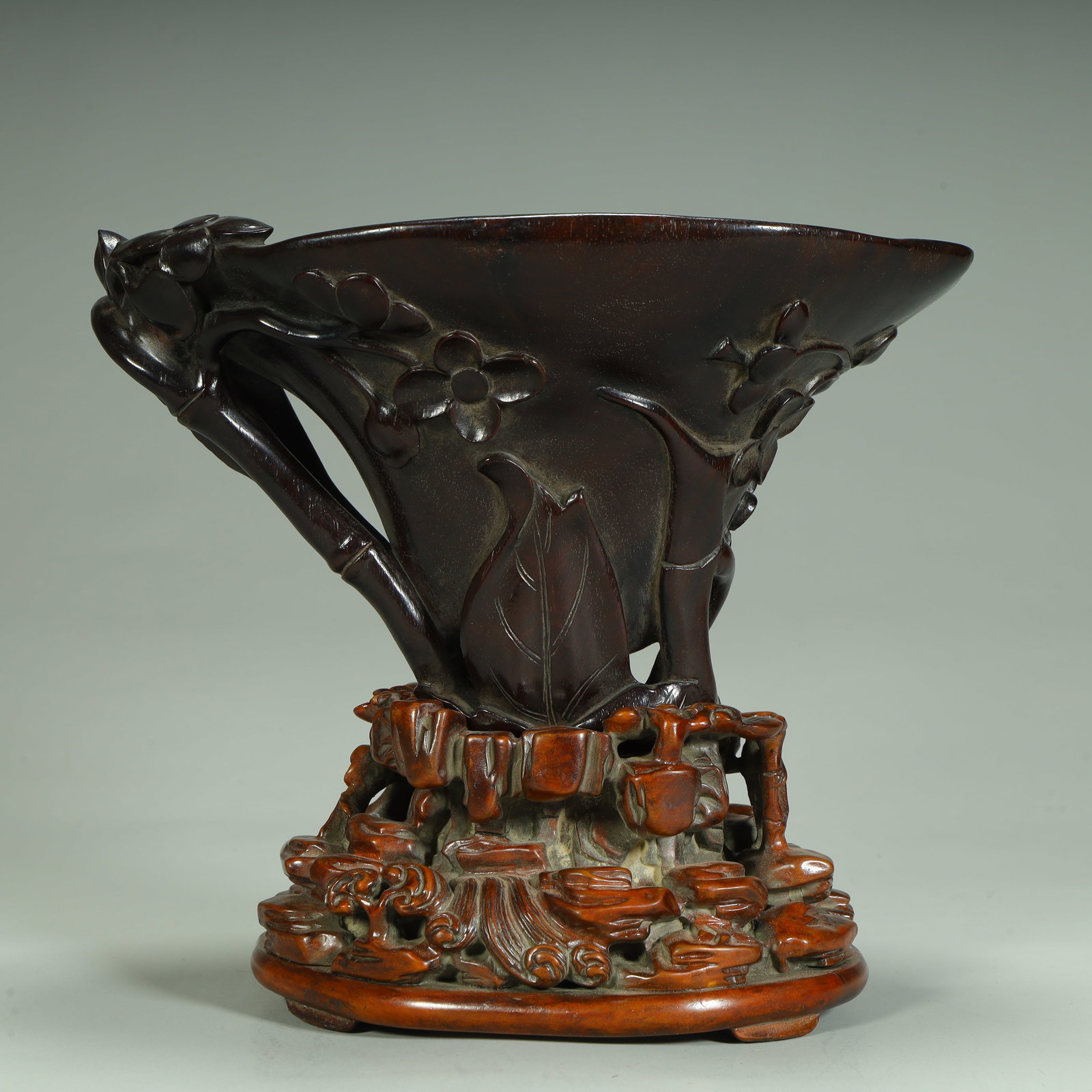 A Qing Dynasty rosewood carved cup in the shape of rhinoceros horn, (1 of 13)