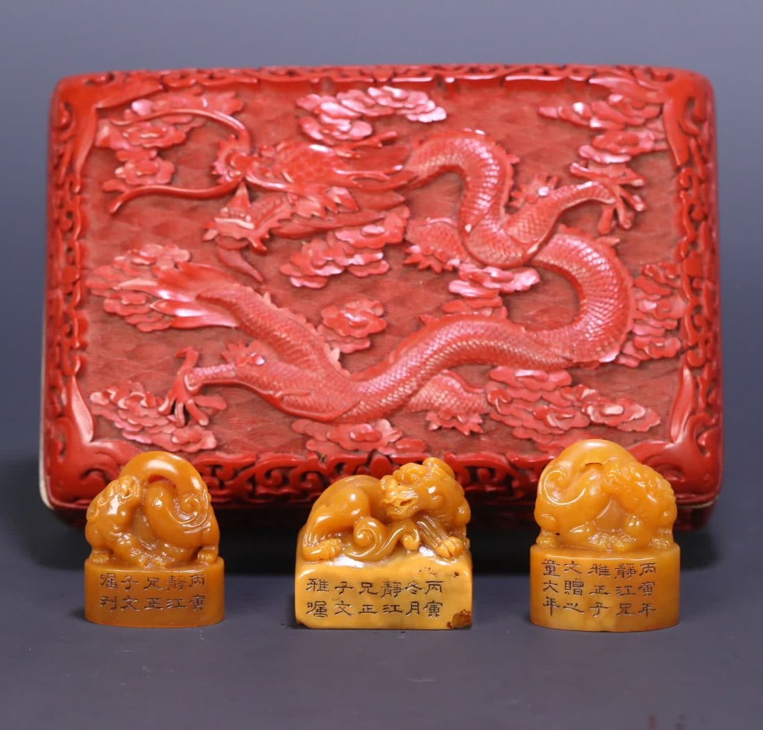 A set of red dragon pattern boxes with three yellowstone seals of the beast button field of the (1 of 9)