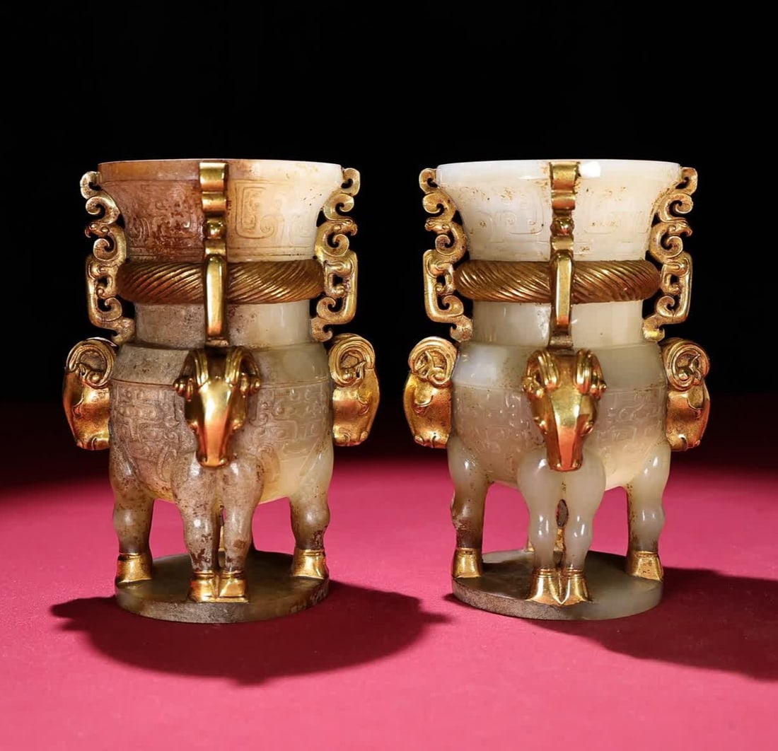 A pair of Han Dynasty jade-gilt sheep's head bottles: A pair of jade-gilt sheep's head bottles from the Han Dynasty SIZE: 150x83mm W:1538g (The Dimensions Of All Batches Are Manually Measured.If You Need More Detailed Information, Please Contact Our