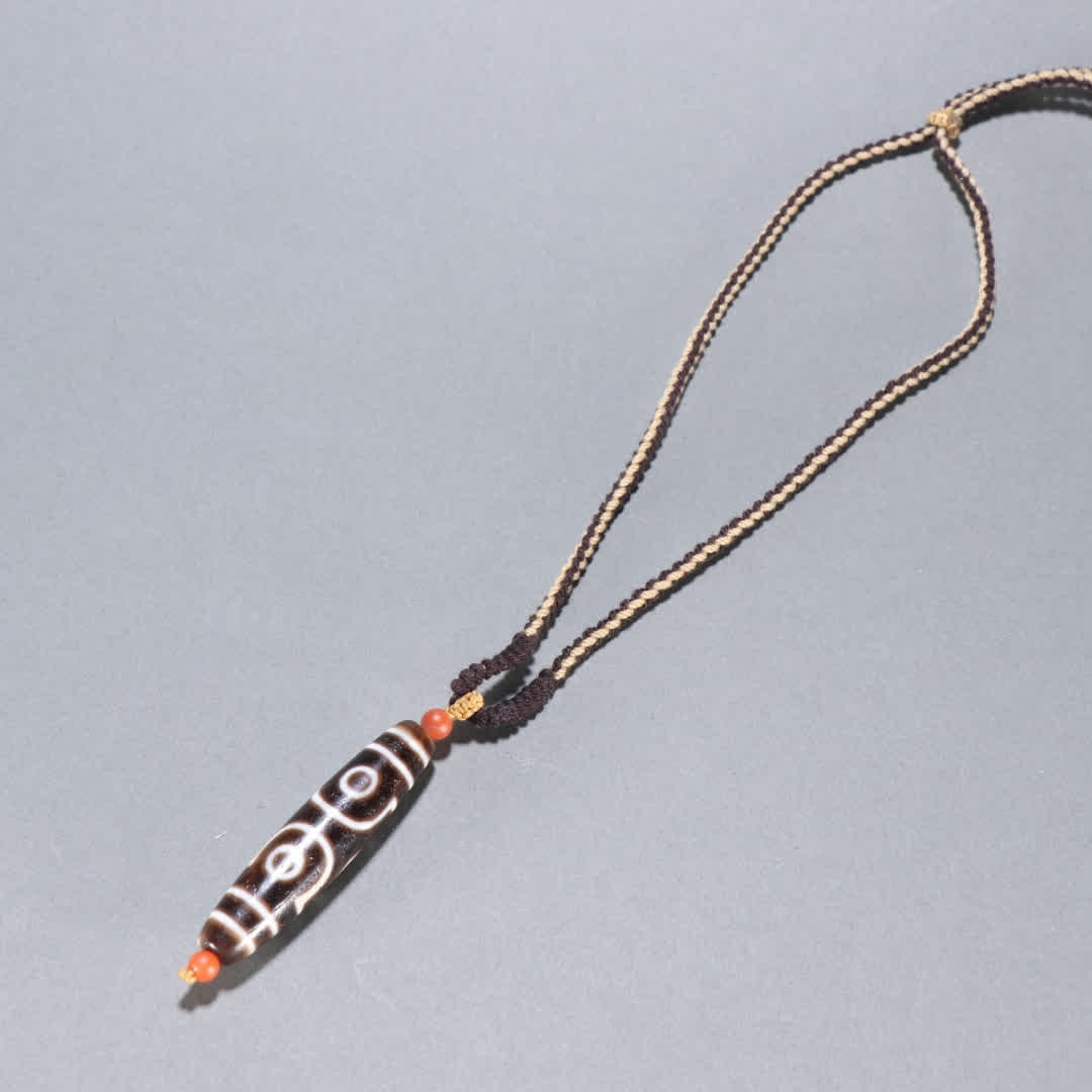 A Qing Dynasty three-eyed Dzi pendant (1 of 9)