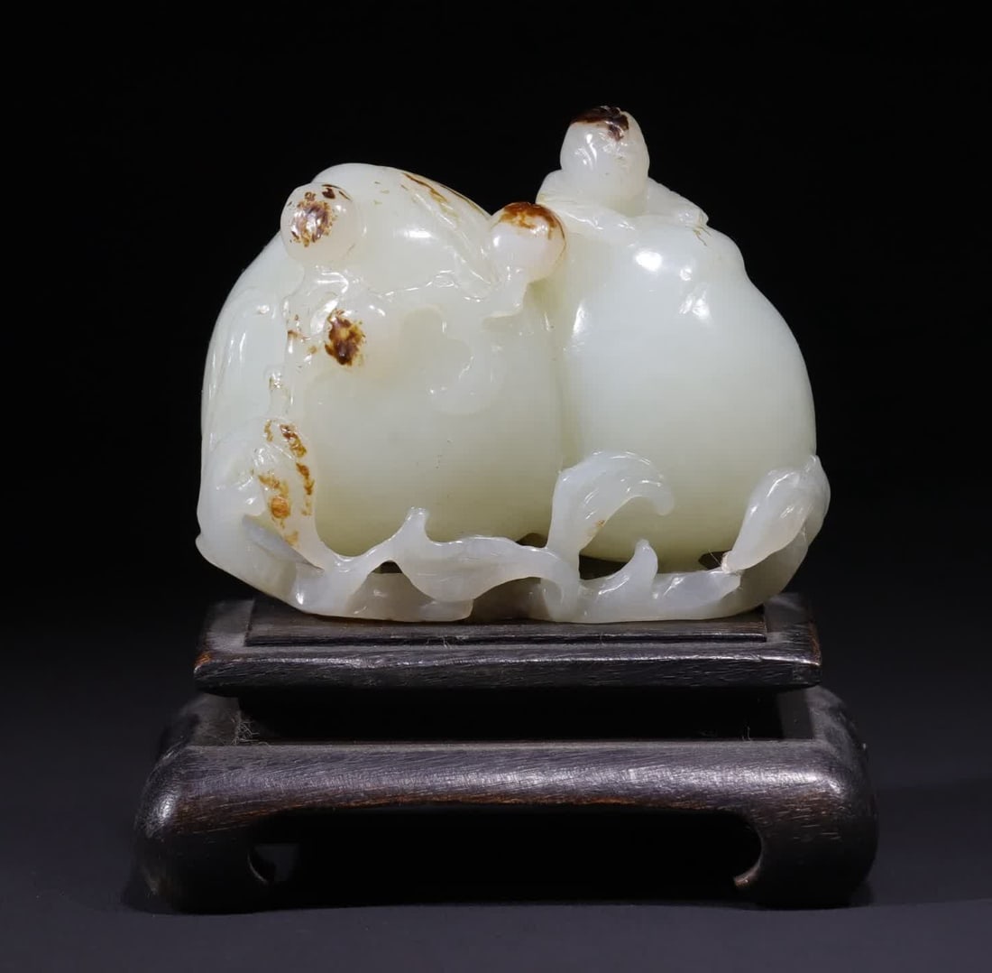 A Qing Dynasty white jade jujube red-skinned boy offered a birthday peach (1 of 9)