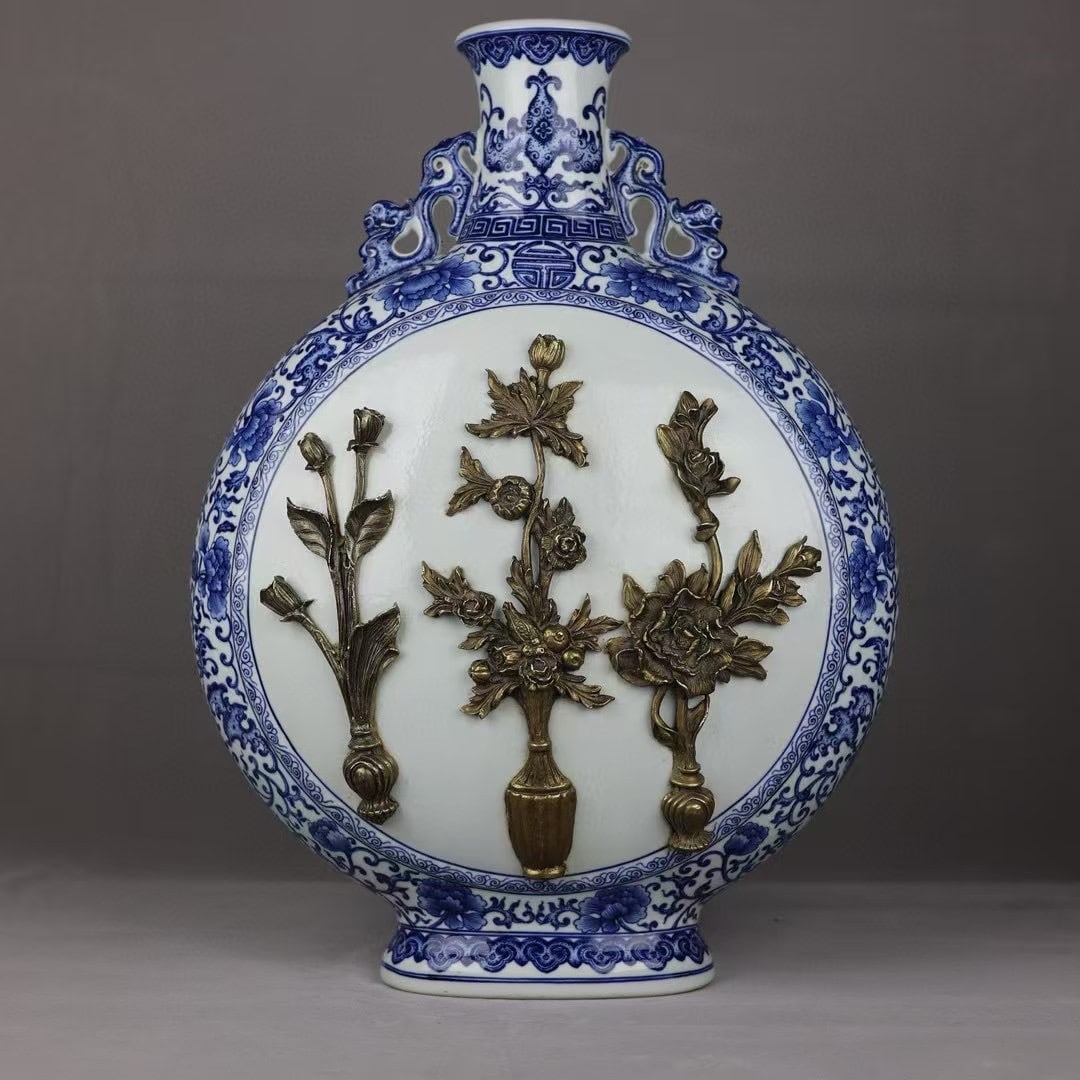 An Exquisite Blue and White Inlaid Bronze Bats and Peach Pattern Lotus Pattern Flower Pattern: An Exquisite Blue and White Inlaid Bronze Bats and Peach Pattern Lotus Pattern Flower Pattern Double-Ears Vase Qing Dynasty, China Qianlong Six-character Mark Size:58.5cmx41cm (The Dimensions Of All B
