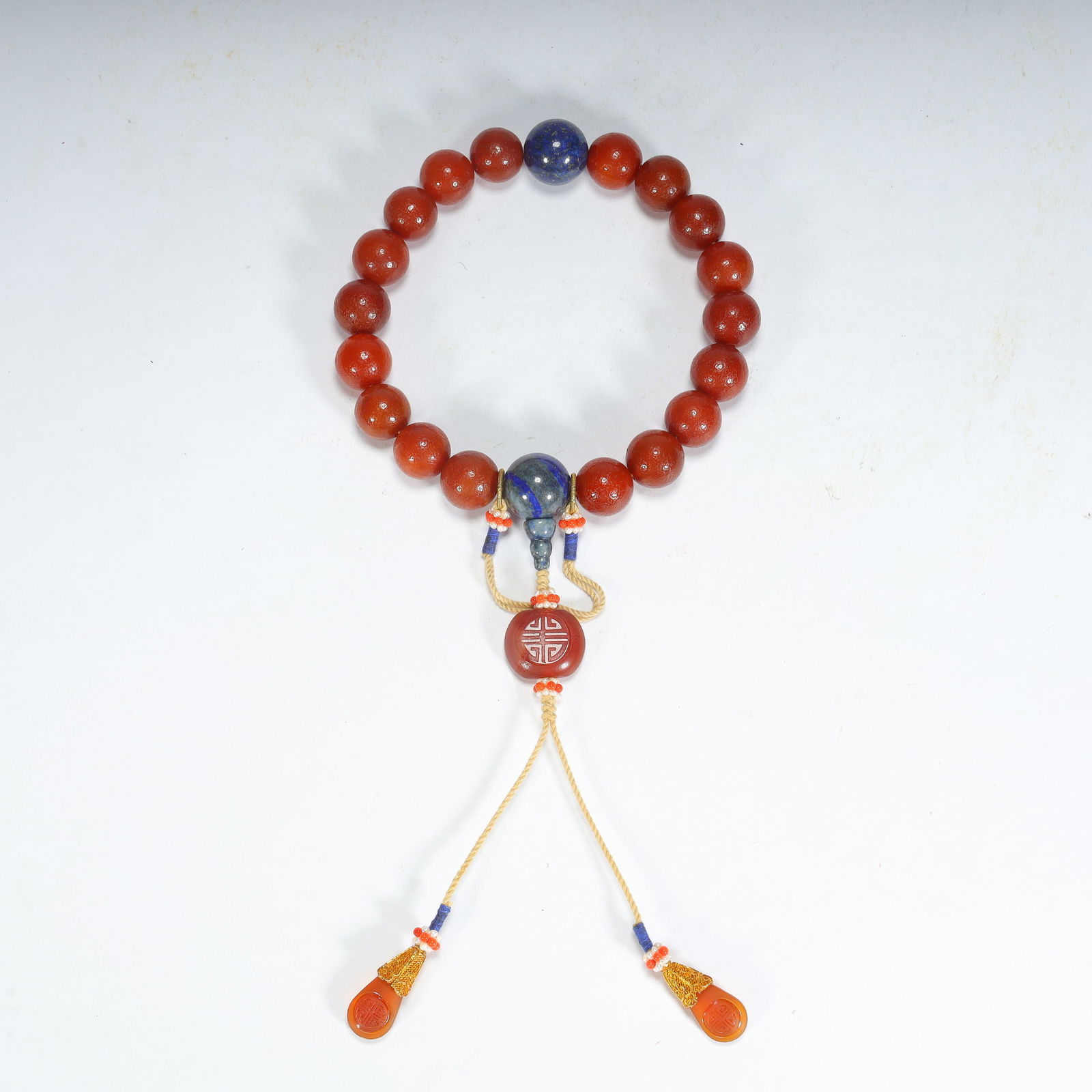 A Qing Dynasty southern red agate with lapis lazuli eighteen bracelet (1 of 9)
