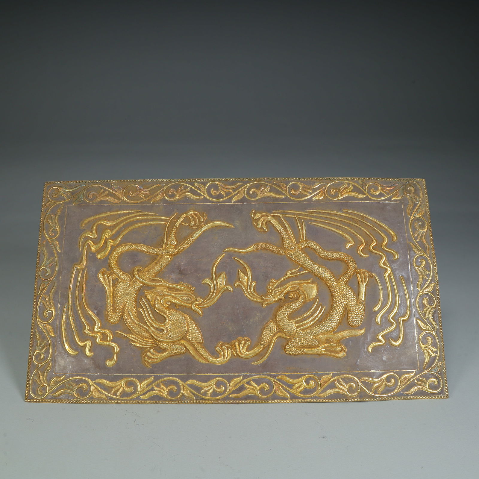 A silver-gilt double dragon pattern panel from the Tang Dynasty: Tang Dynasty silver gilt double dragon pattern panel Size:H:15cmW:27cmW:142g (The Dimensions Of All Batches Are Manually Measured.If You Need More Detailed Information, Please Contact Our Customer Ser