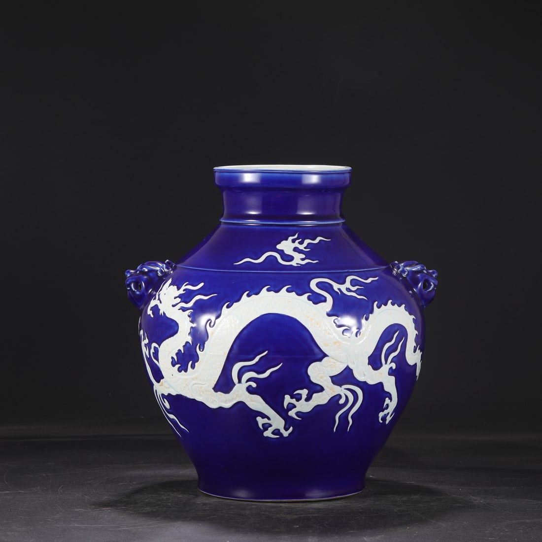 A large jar with a blue glaze left blank and carved cloud dragon pattern dog head from the Yuan (1 of 9)