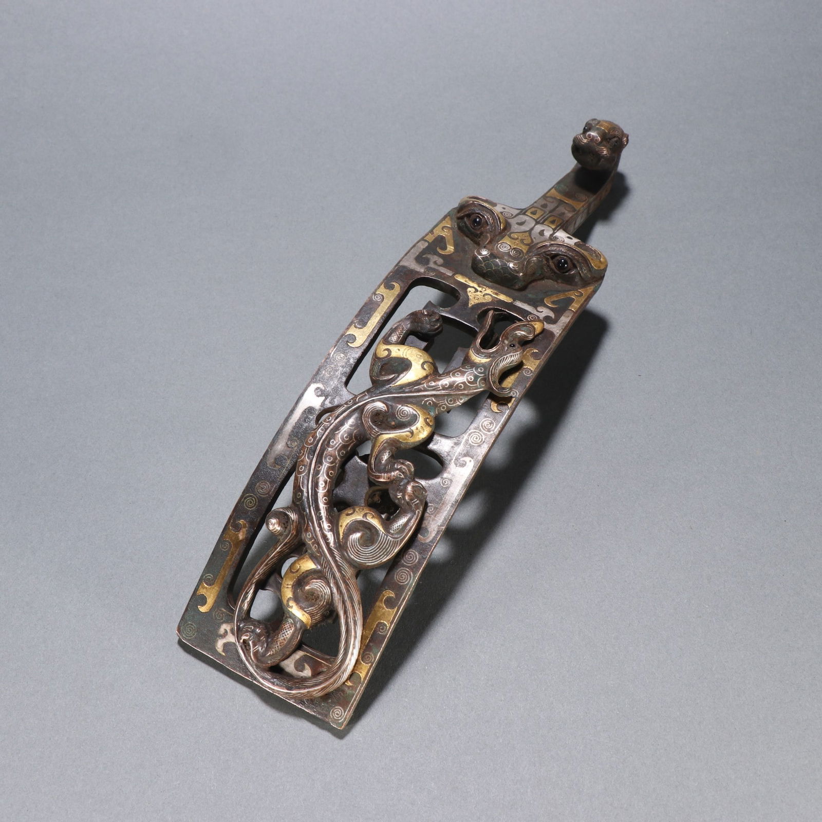A bronze gold and silver dragon belt hook from the Han Dynasty (1 of 9)
