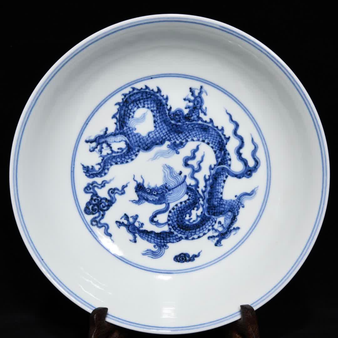 A Ming Xuande blue and white dragon pattern plate: Ming Xuande blue and white dragon pattern plate SIZE: H:5.1cm D:22.2cm (The Dimensions Of All Batches Are Manually Measured.If You Need More Detailed Information, Please Contact Our Customer Service B