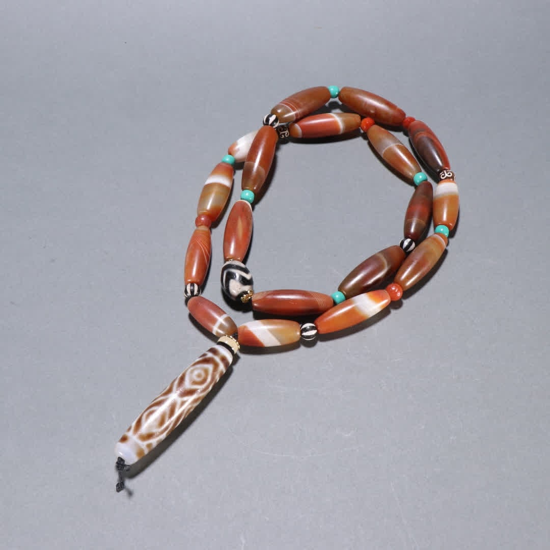 A Qing Dynasty agate six-eyed Dzi necklace (1 of 9)