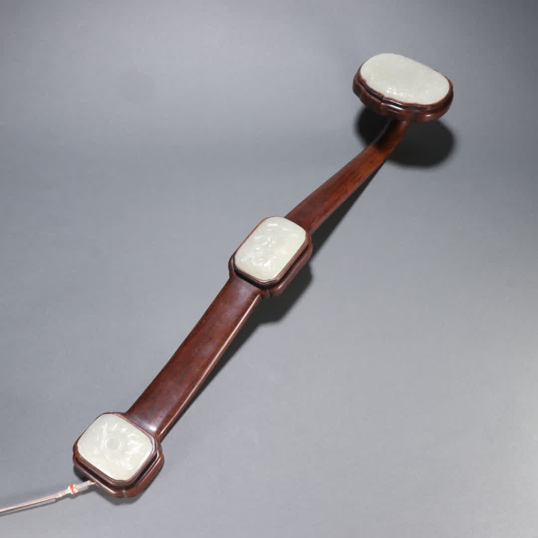 A Qing Dynasty Huanghuali inlaid jade longevity pattern ruyi handle (1 of 9)