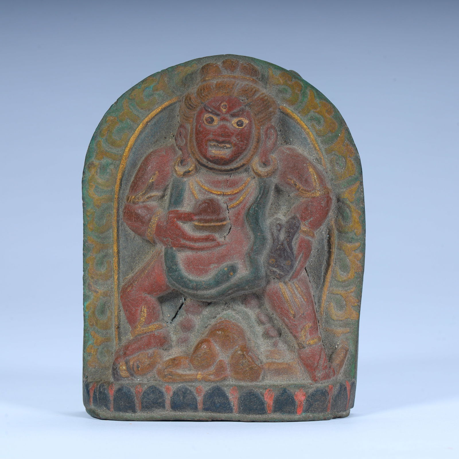 A Tibetan Buddhist red god of wealth rubbing the statue (1 of 9)
