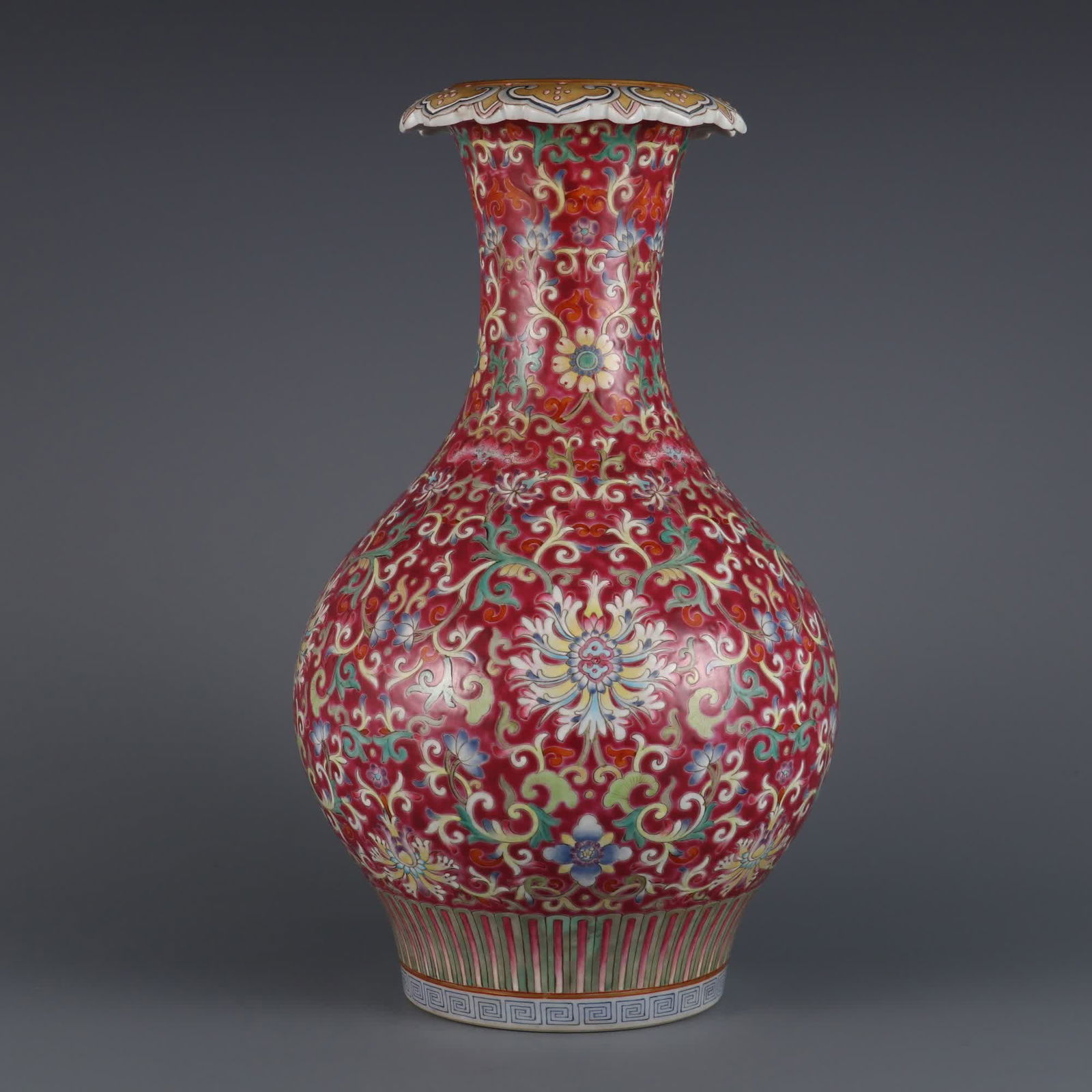 A carmine red pastel passionflower pattern flower mouth bottle made in the Qianlong period of the: Qing Qianlong year carmine red ground pastel passionflower pattern flower mouth bottle SIZE: H:33.6cm mouthD:8.6cm (The Dimensions Of All Batches Are Manually Measured.If You Need More Detailed Inform