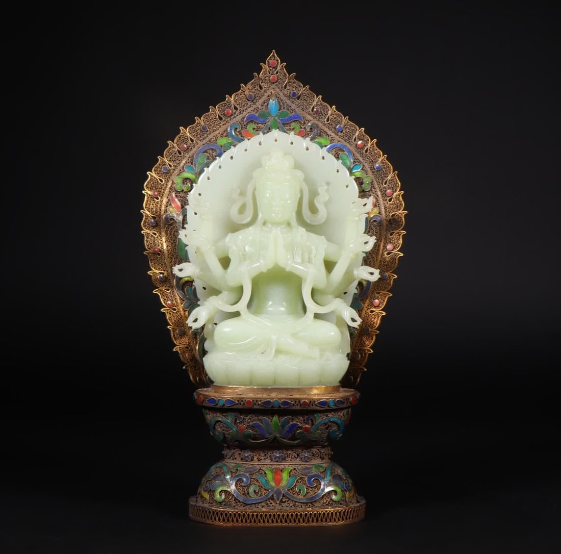 A Hetian jade eight-armed Guanyin statue wearing a silver gilt filigree seat: The eight-armed Guanyin statue of Hetian jade wears a silver-gilt filigree seat SIZE: L:16cm W:7.3cm H:29.5cm W:1478g (The Dimensions Of All Batches Are Manually Measured.If You Need More Detailed Inf