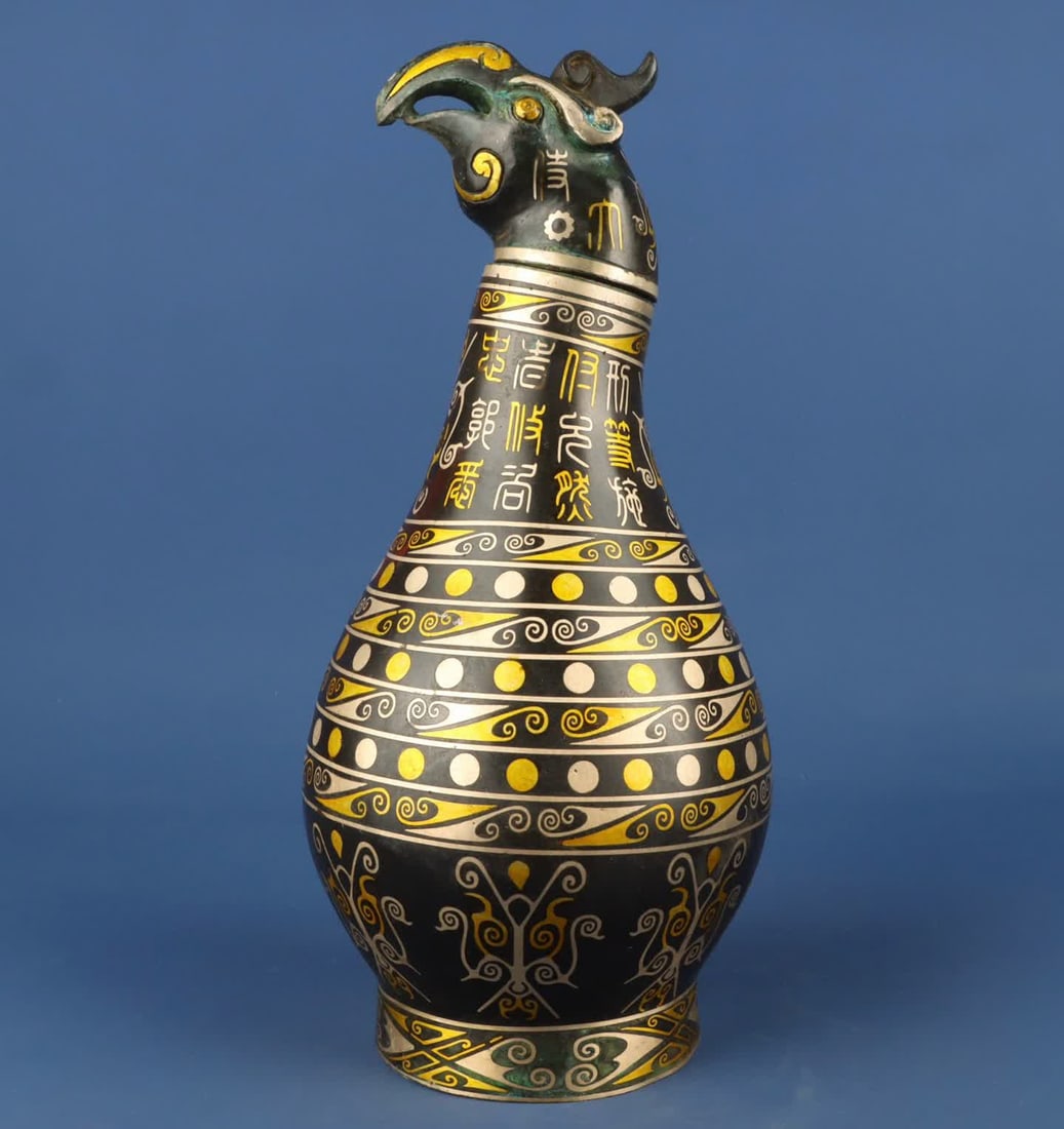 A Han Dynasty_Bronze Cuo gold and silver phoenix head vase: Han Dynasty_Bronze Cuojin Silver Phoenix Head Bottle SIZE: W:2050g L:15cm H:33cm (The Dimensions Of All Batches Are Manually Measured.If You Need More Detailed Information, Please Contact Our Customer