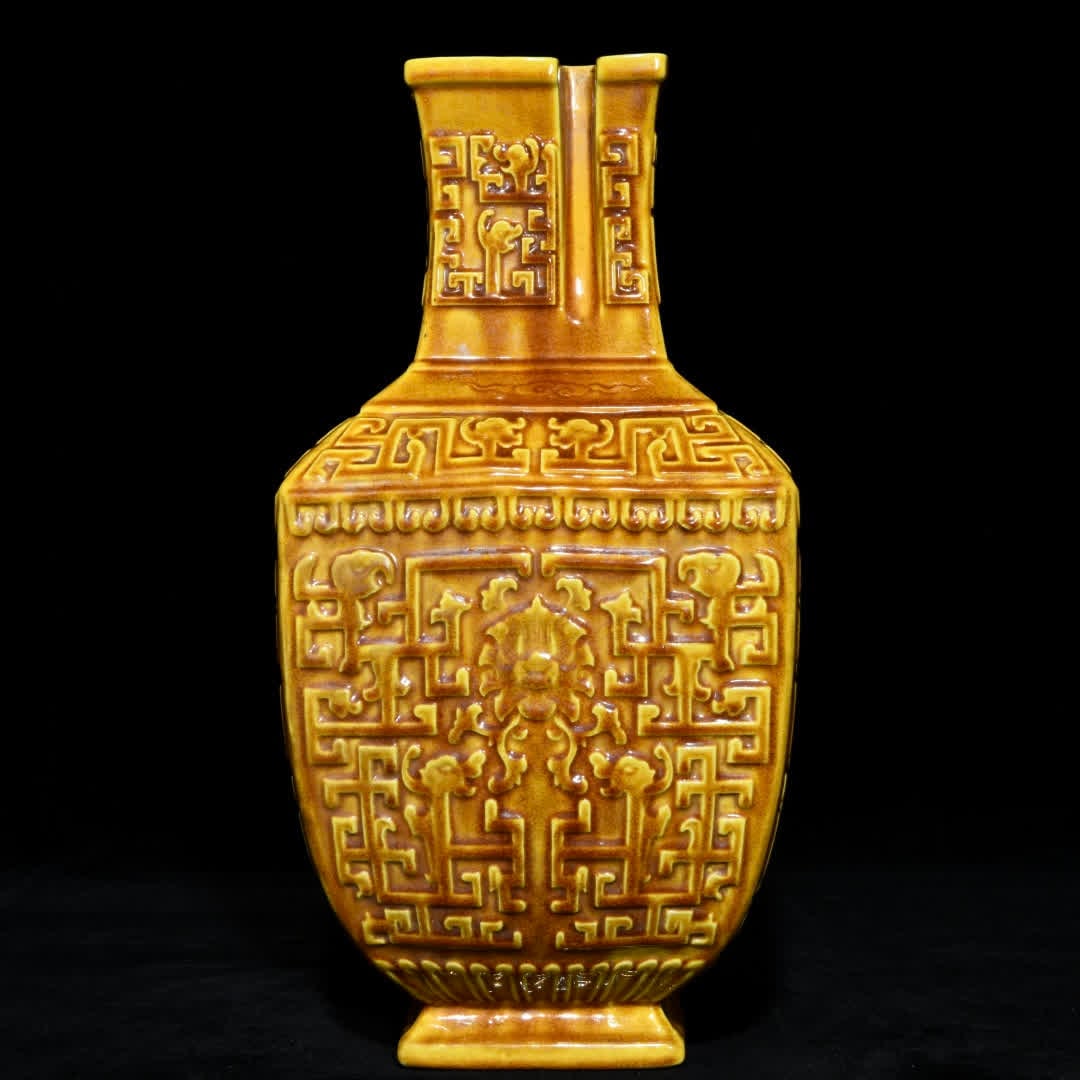 A square bottle of Ming Hongzhi's delicate yellow glaze relief flower pattern: Ming Hongzhi delicate yellow glaze relief flower pattern square bottle SIZE: H:32.5cm D:16.2cm (The Dimensions Of All Batches Are Manually Measured.If You Need More Detailed Information, Please Contac