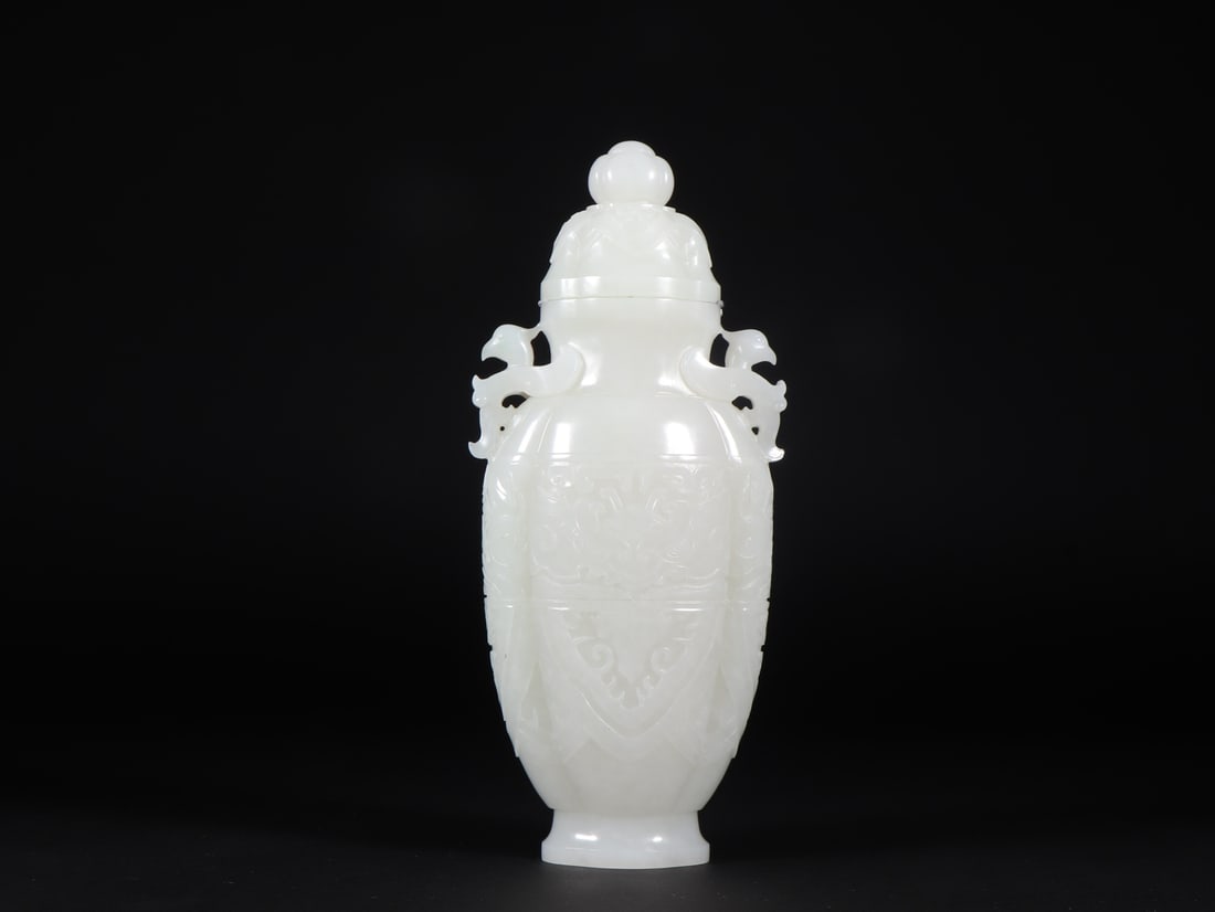 An Exquisite White Jade Beast-Face Pattern Double-Ears Vase: An Exquisite White Jade Beast-Face Pattern Double-Ears Vase Qing Dynasty, China Size:8.8cmx5.2cmx20.5cm Weight:622g (The Dimensions Of All Batches Are Manually Measured.If You Need More Detailed Infor