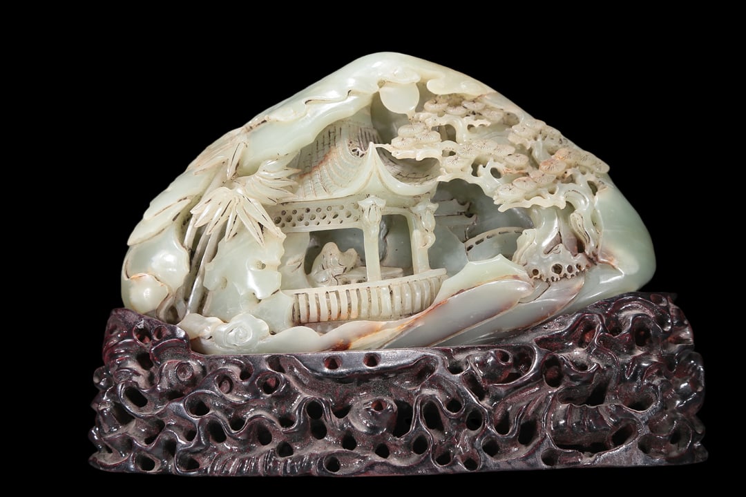 An Elaborate White Jade 'Landscape& Figure' Decoration: An Elaborate White Jade 'Landscape& Figure' Decoration. Carved in high relief with lush pines, a robed figure and an ancient Chinese pavilion amidst a rocky landscape. Chinese Qing Dynasty. Size:23cmx