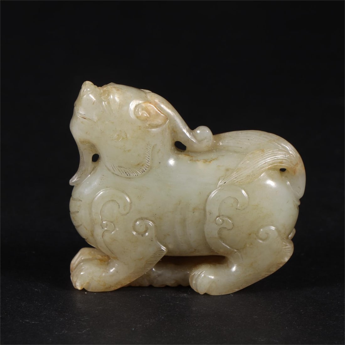 A Qing Dynasty Hetian jade seed material auspicious beast (1 of 9)