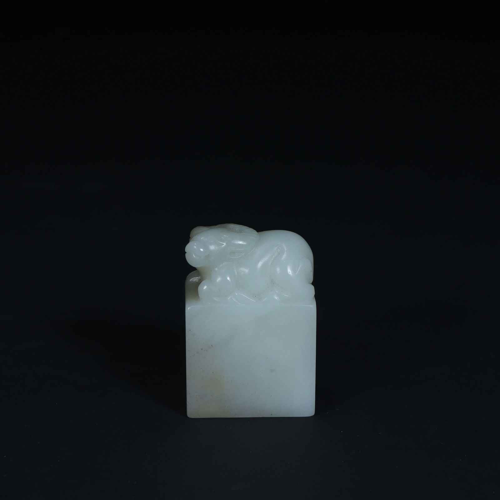 A Qing Dynasty Hetian white jade beast button seal (1 of 9)
