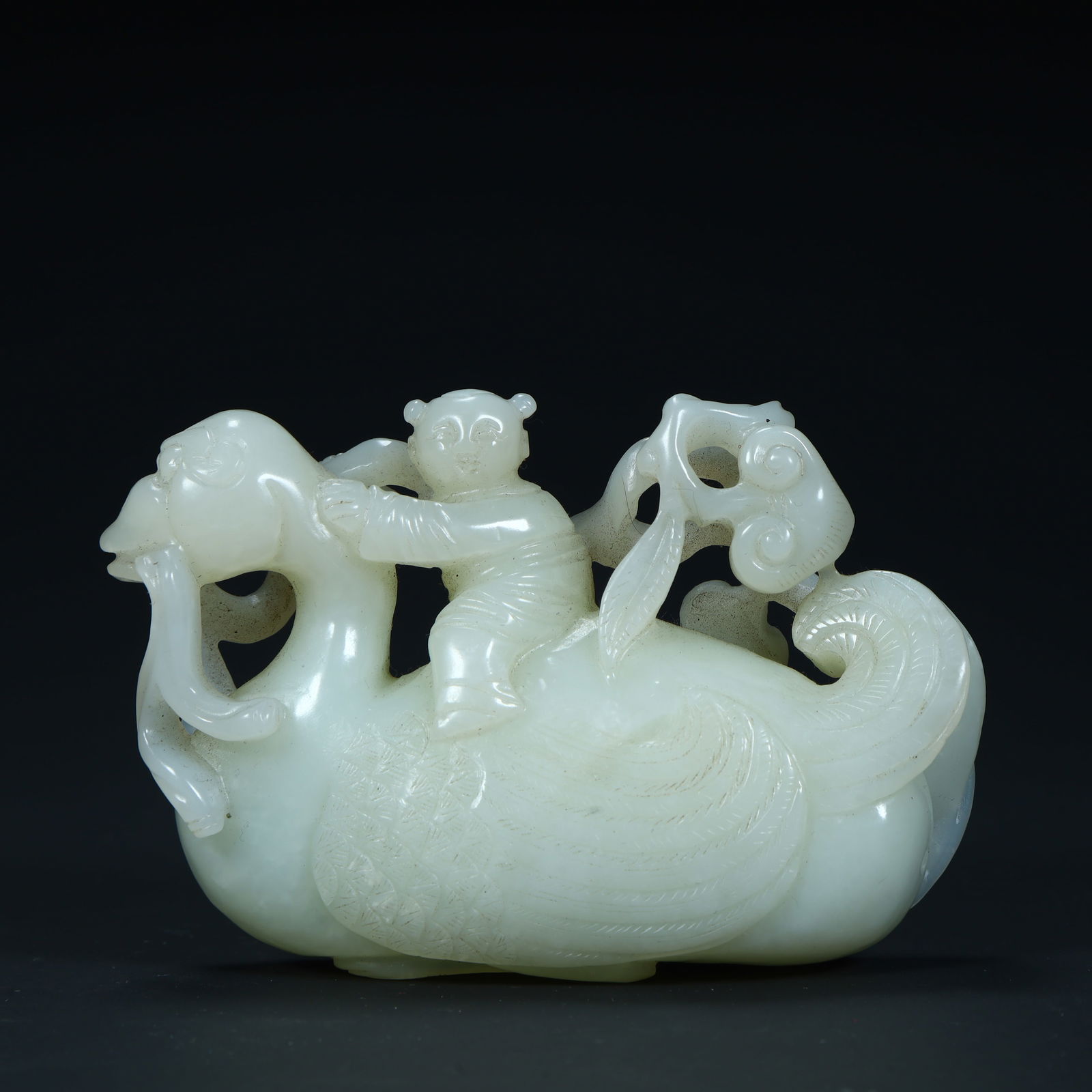 A Qing Dynasty Hetian white jade carving boy riding a goose ornament (1 of 10)