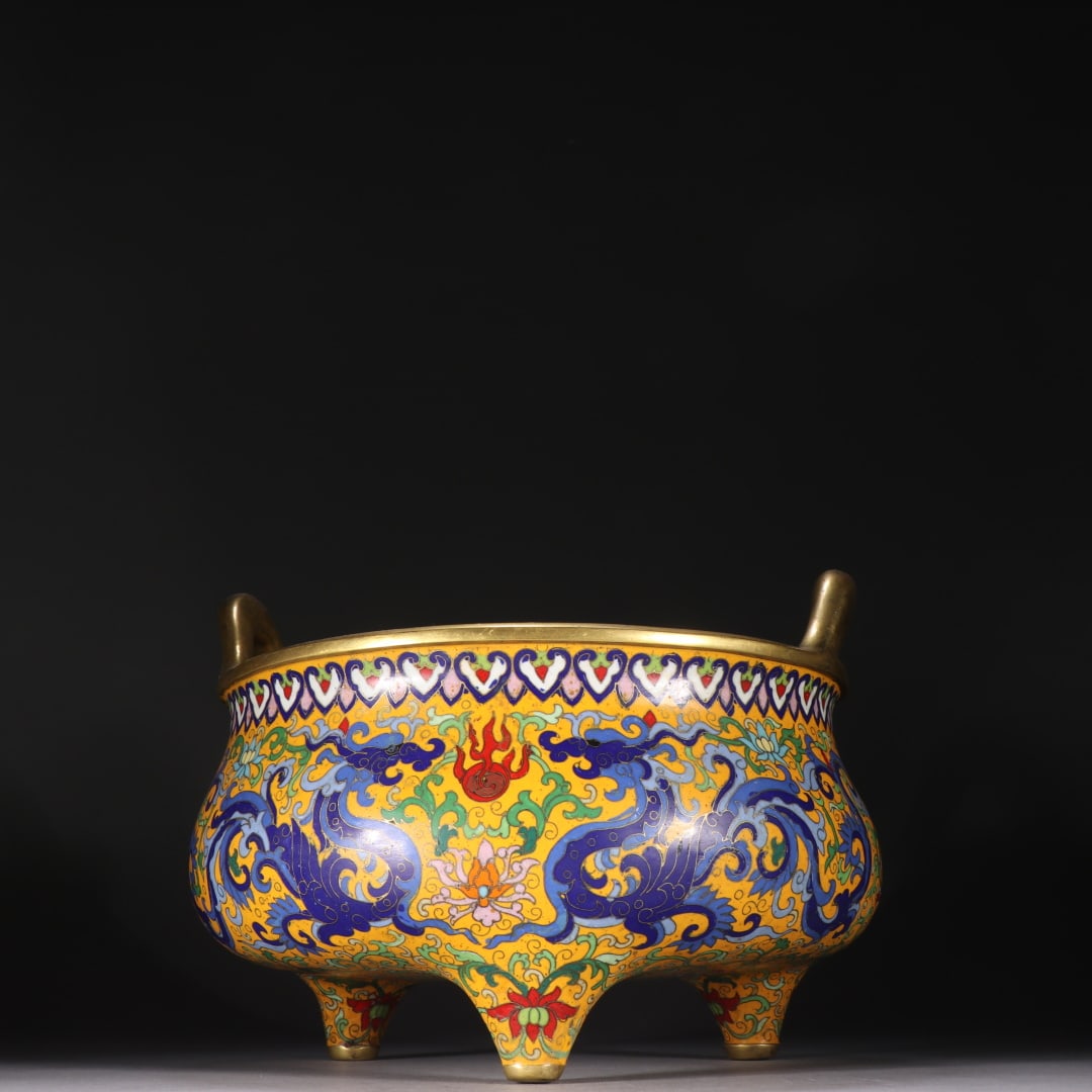A copper-gilt cloisonné double dragon play bead three-legged incense burner made in the Xuande era: The copper gilt cloisonné double dragon play bead three-legged incense burner made in the Xuande era of the Ming Dynasty Size:H:16.6cmW:23cmW:4.3778kg (The Dimensions Of All Batches Are Manually Meas