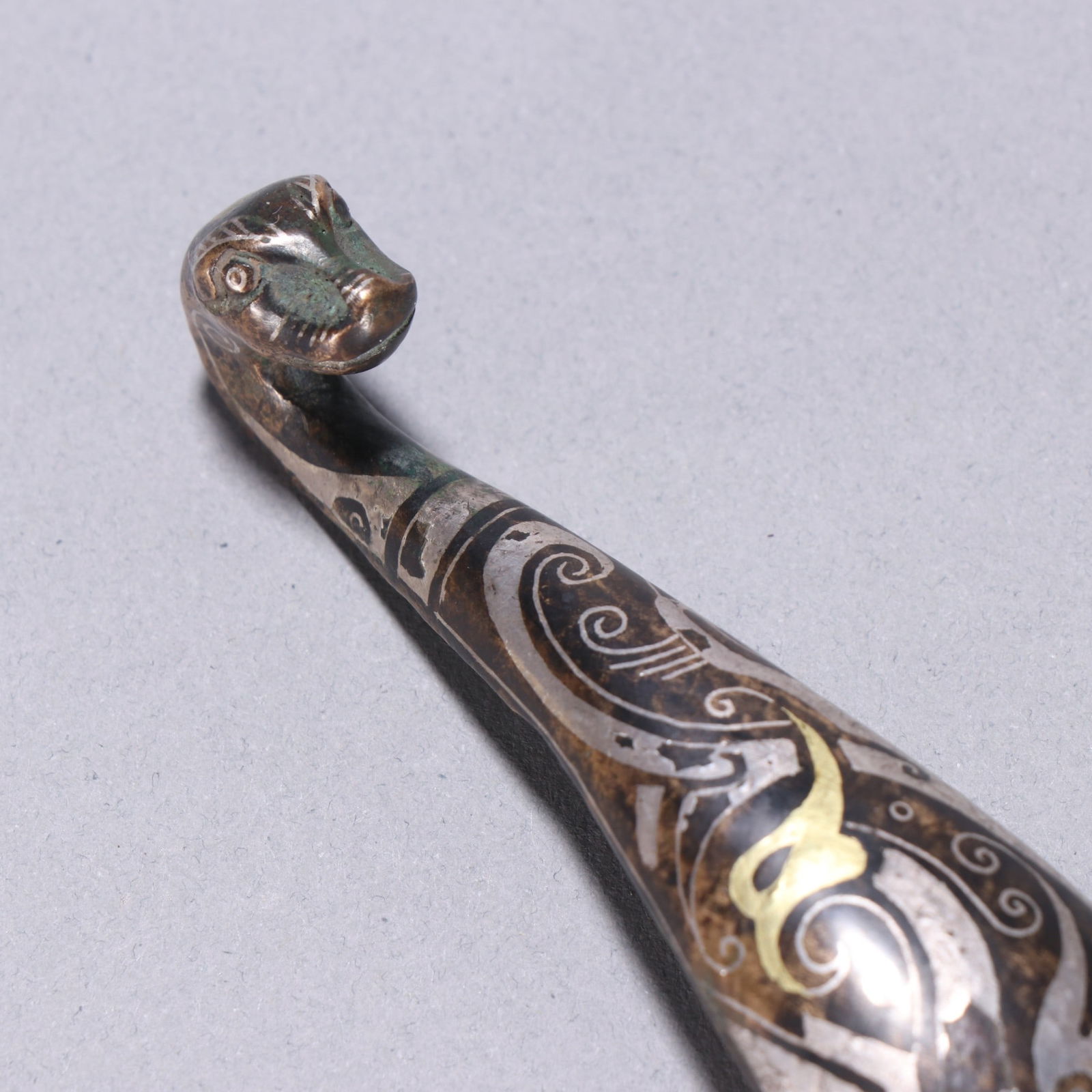 A fine copper wrong gold and silver strap hook - 2