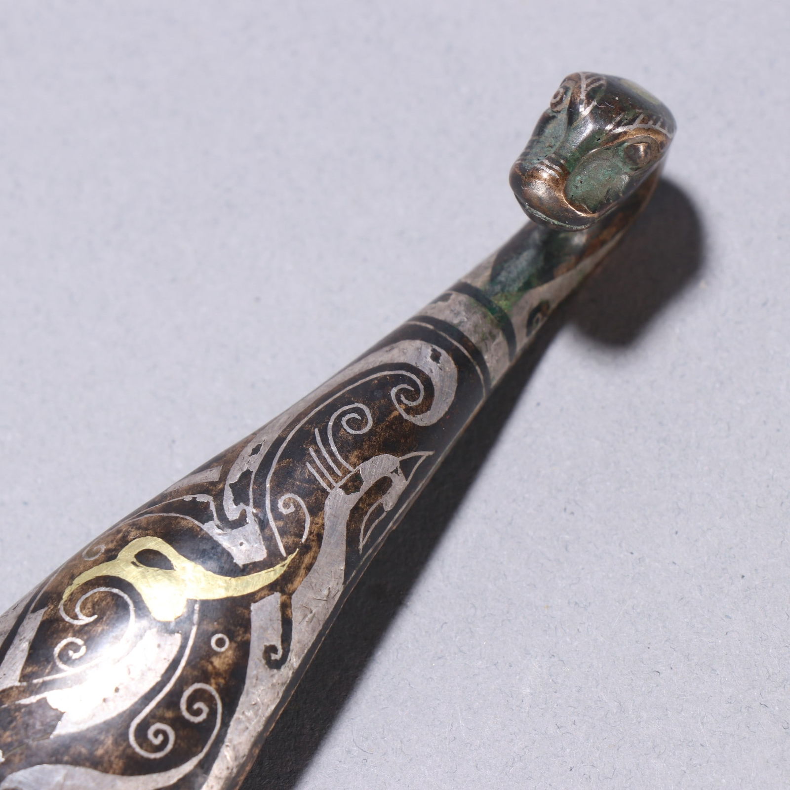 A fine copper wrong gold and silver strap hook - 6