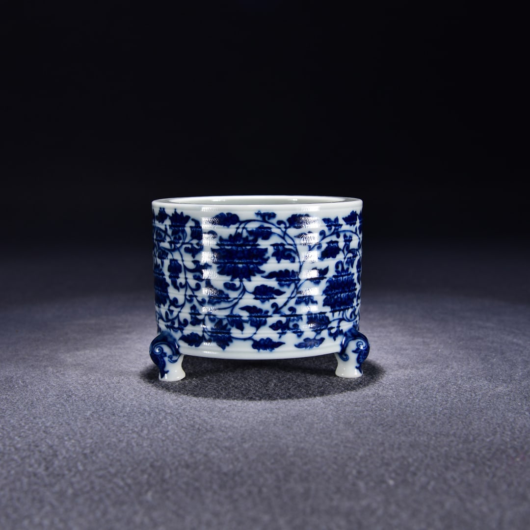 A three-legged furnace with a blue and white entwined lotus pattern made in the Qianlong period of (1 of 9)