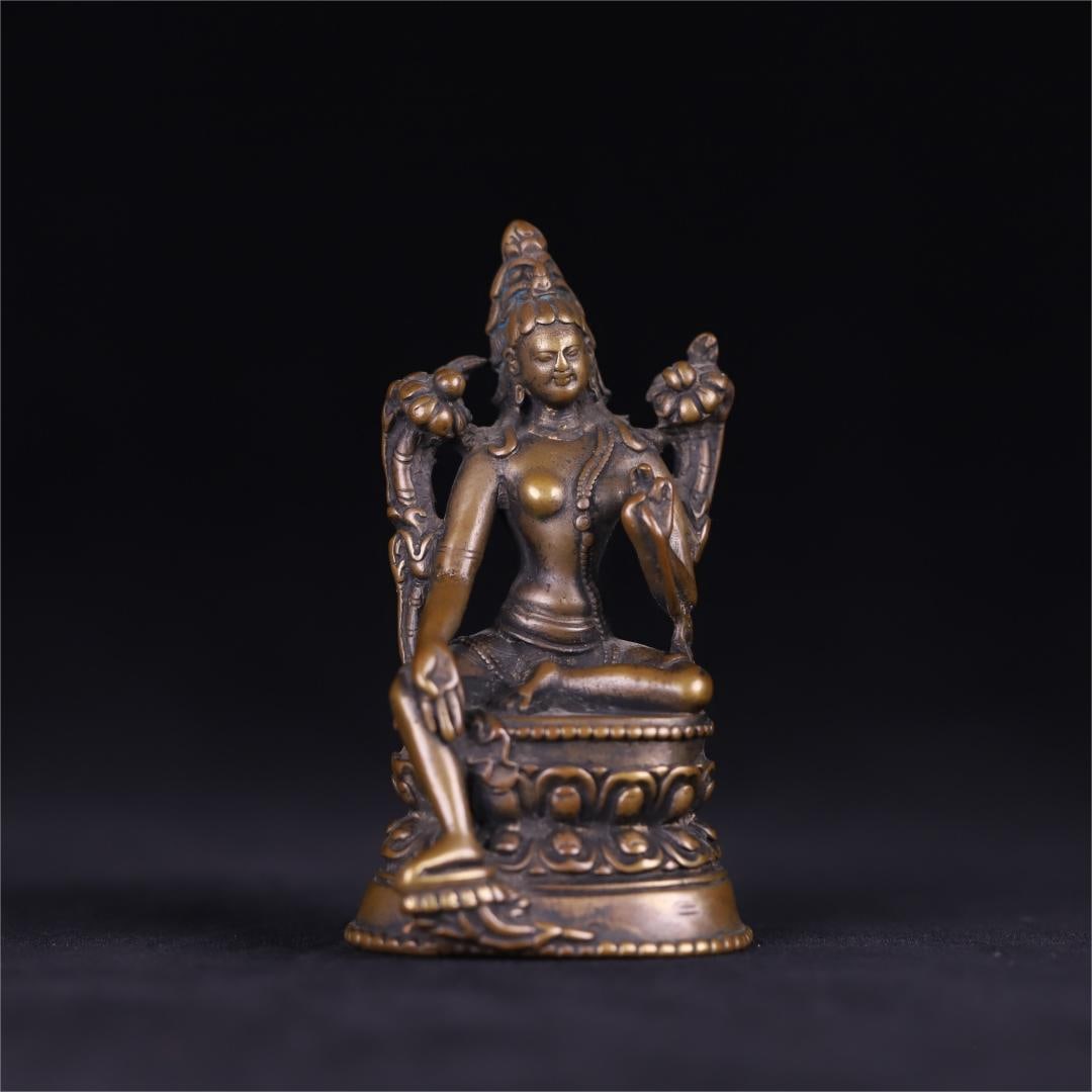 A seated statue of Tara in a bronze tube in the Qing Dynasty: The Qing Dynasty's bronze green Tara seated statue is in a comfortable sitting posture, the right leg is drooping, the left leg is crossed, the right hand is tied with a wish seal, the left hand is