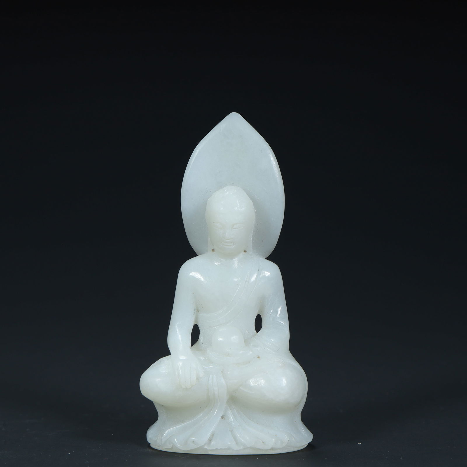 A seated statue of Shakyamuni Buddha carved in Hetian white jade in the Qing Dynasty (1 of 8)