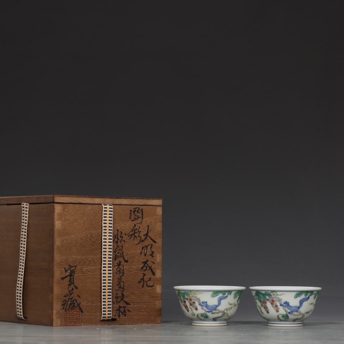 A Pair of Exquisite Doucai Squirrel and Grapes Pattern Cup: A Pair of Exquisite Doucai Squirrel and Grapes Pattern Cup Ming Dynasty, China Chenghua Six-character Mark Size:4cmx7.8cm (The Dimensions Of All Batches Are Manually Measured.If You Need More