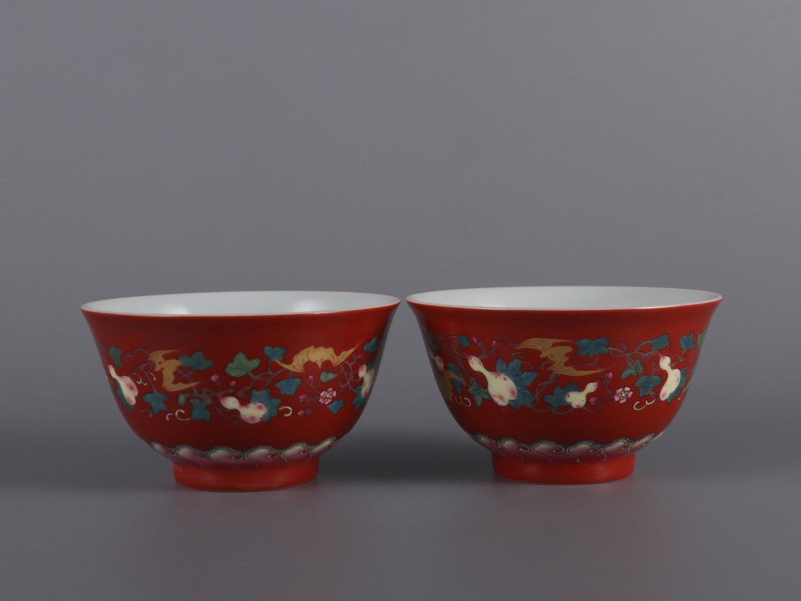 A pair of small bowls with a red coral background and gold-painted flute pattern made in the Qing: A pair of small bowls made in the Yongzheng era of the Qing Dynasty with coral red background pastel painted with a blessing pattern SIZE: H:5.2cm mouthD:8.8cm (The Dimensions Of All Batches Are Manua