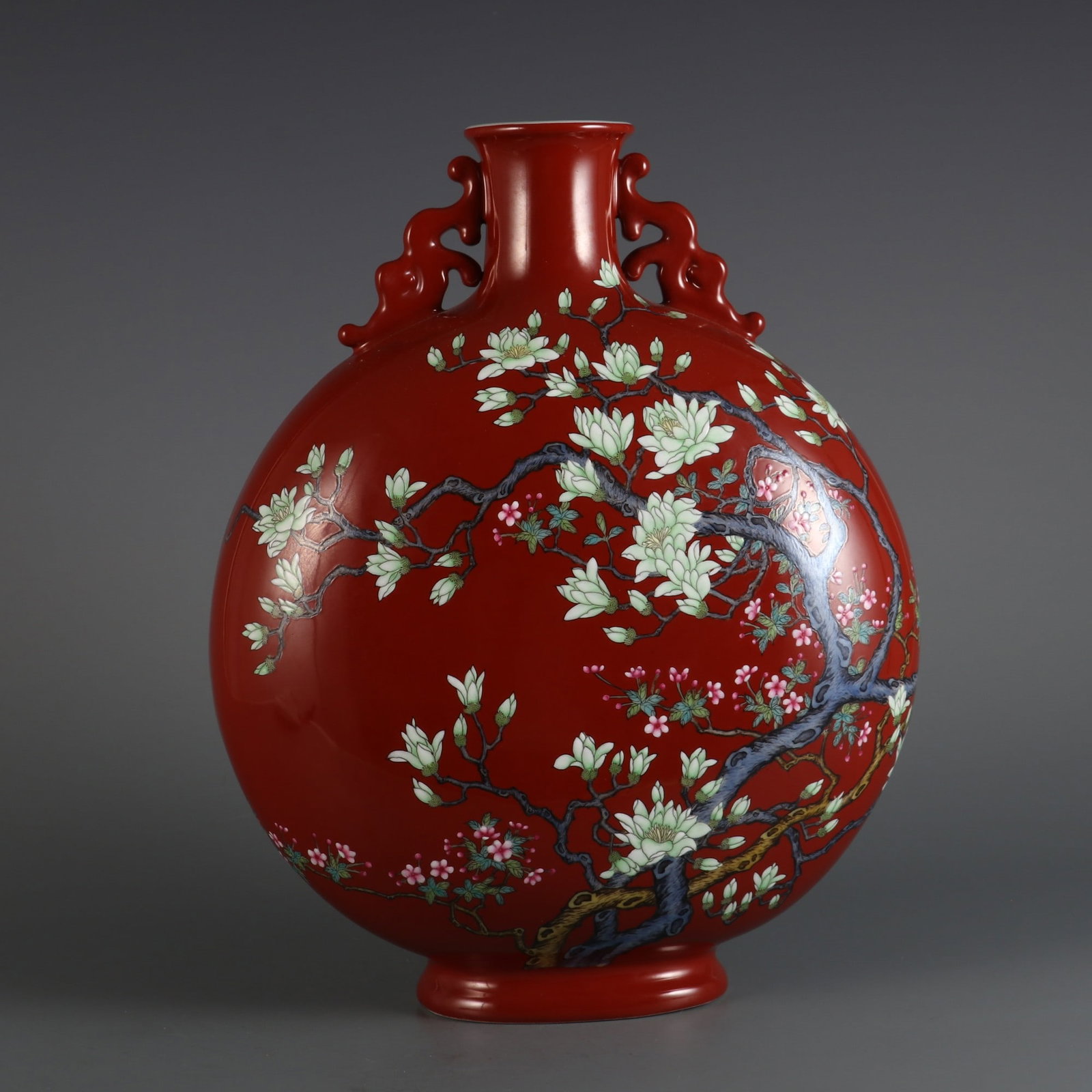 An Exquisite Enamel Coral Red Glazed Flower Pattern Double-Ears Vase: An Exquisite Enamel Coral Red Glazed Flower Pattern Double-Ears Vase Qing Dynasty, China Qianlong Four-character Mark Size:31cmx25cm (The Dimensions Of All Batches Are Manually Measured.If You Need Mo